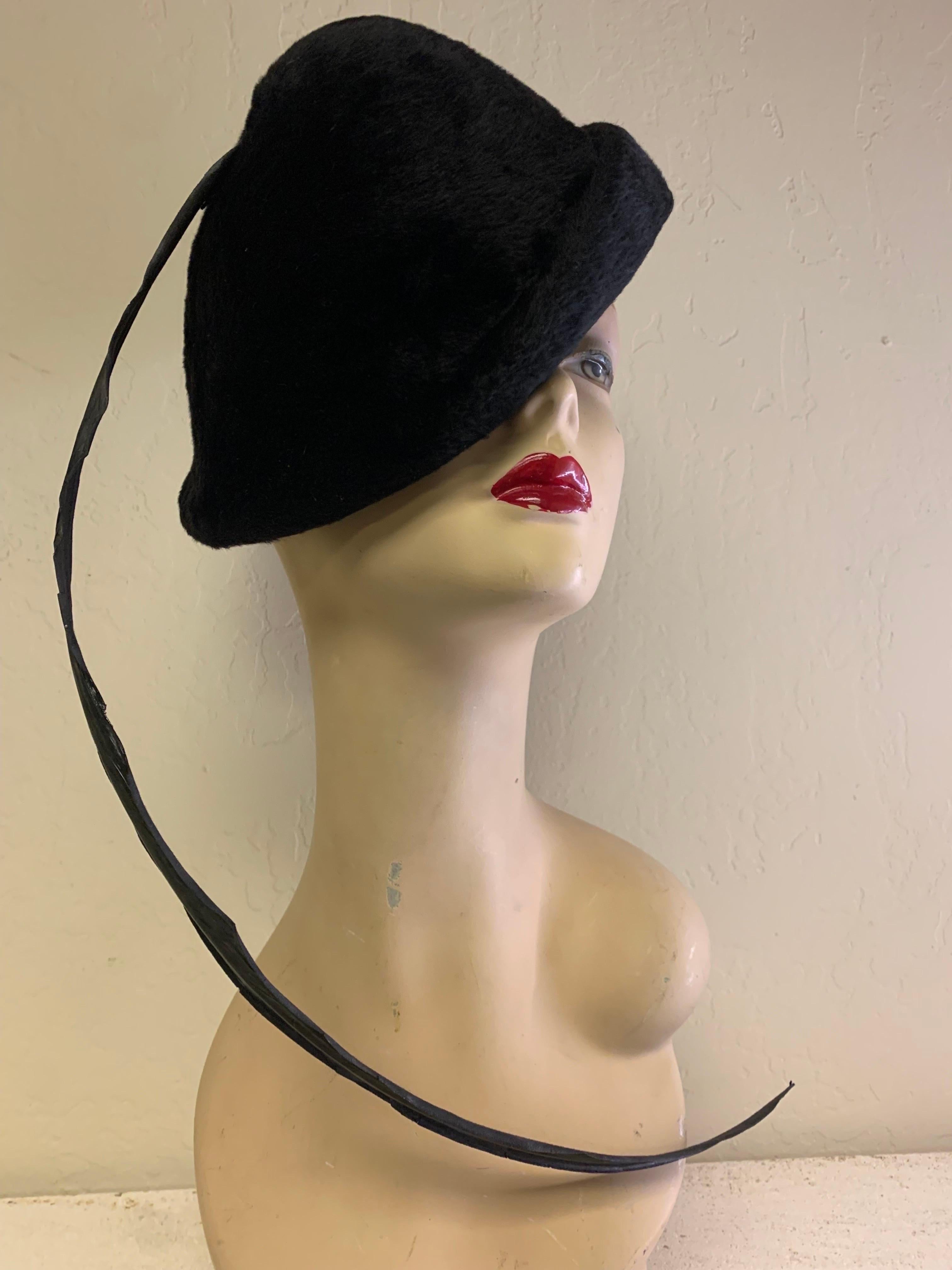 Early 1970s rare Yves Saint Laurent plush fine wool high-crown hat, molded shape with rolled soft edge and one singular extra-long stiffly lacquered pheasant feather. Fits M-L crown.