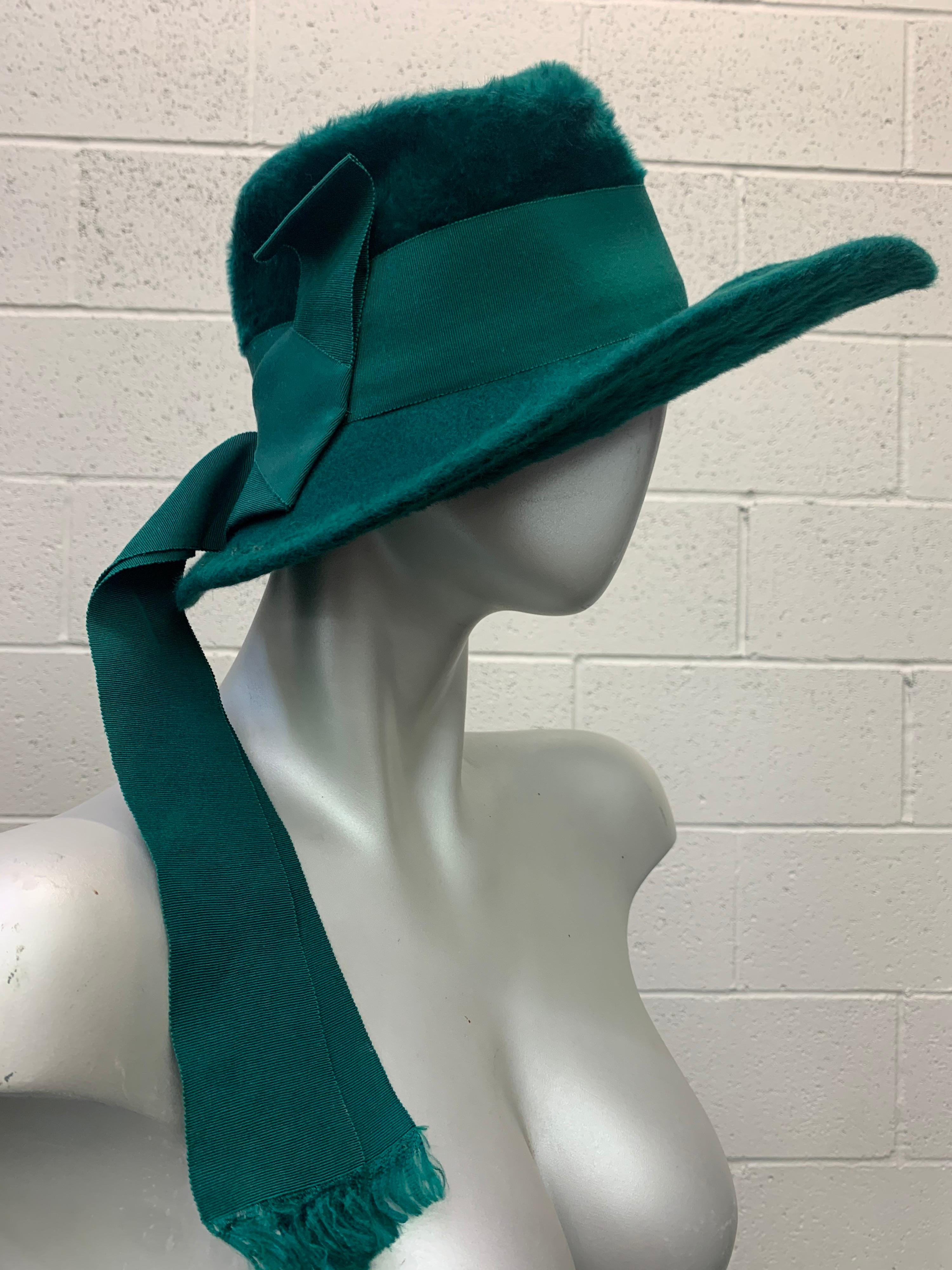 1970’s ultra chic Yves Saint Laurent fur felt Fedora style hat in deep emerald green features a wide coordinating grosgrain ribbon band and ribbon streamers that trail to the back adding flair to this rare beauty .

Hat measures 22 inches and is in