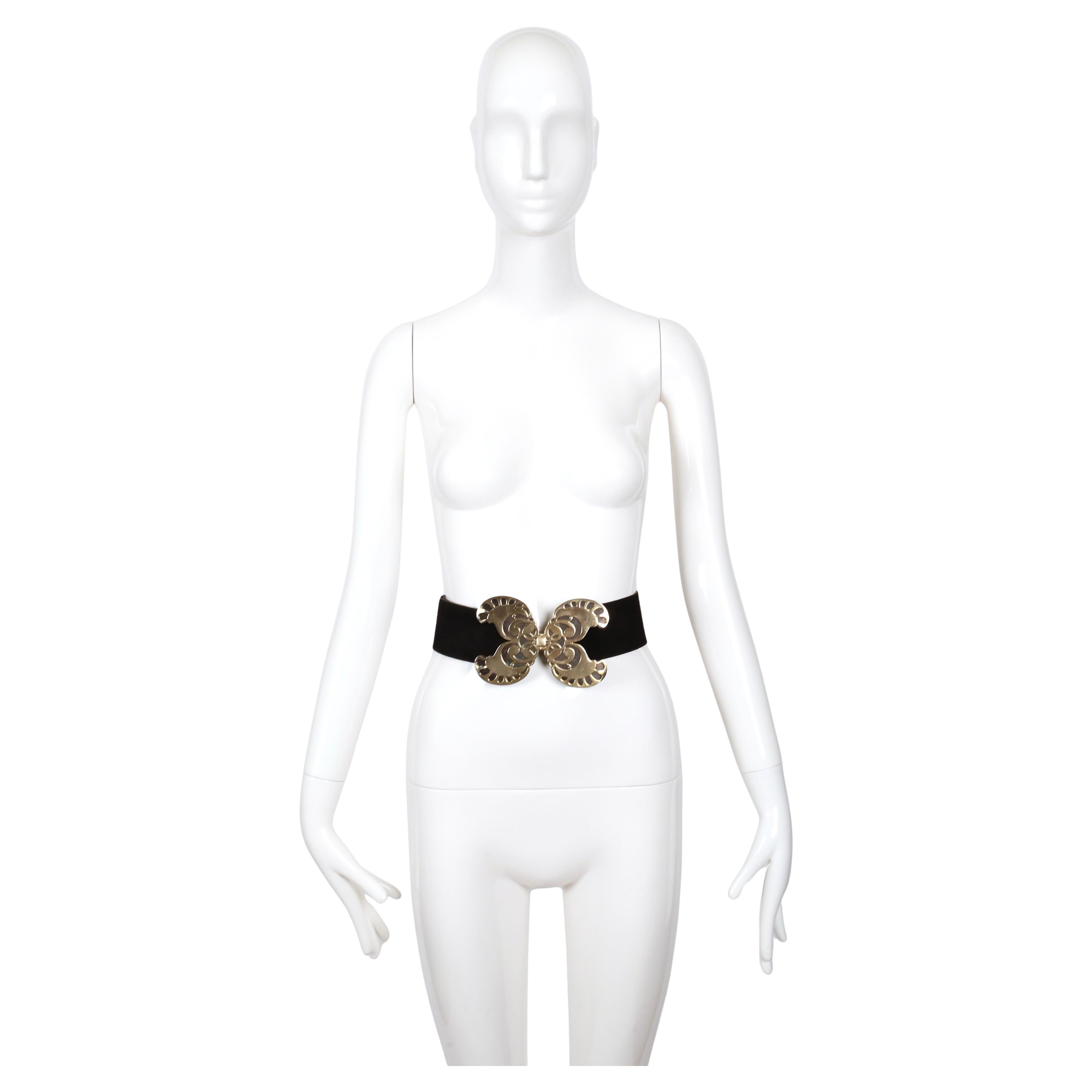 Very rare black suede belt with oversized metal butterfly buckle designed by Yves Saint Laurent dating to 1970 as seen on Yves Saint Laurent himself.    

This belt buckle has a striking Art Deco–inspired butterfly motif. It’s made from two layered