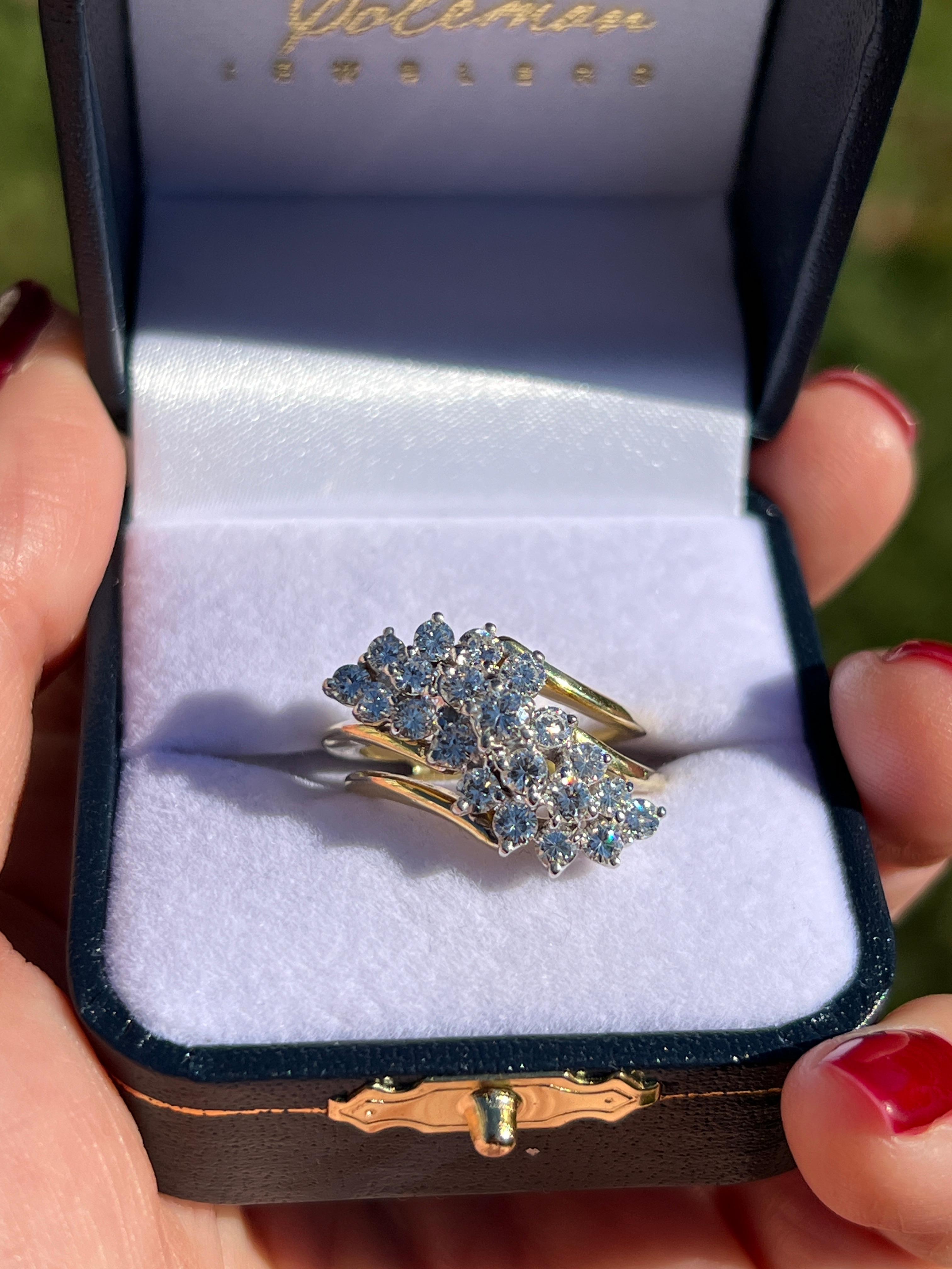 One 1970s 18 karat yellow and white gold elongated waterfall design ring set with twenty-one round brilliant cut diamonds, approximately 1.00 carat total weight with matching G/H color and SI1 clarity. This ring is a size 6.5 and can be resized