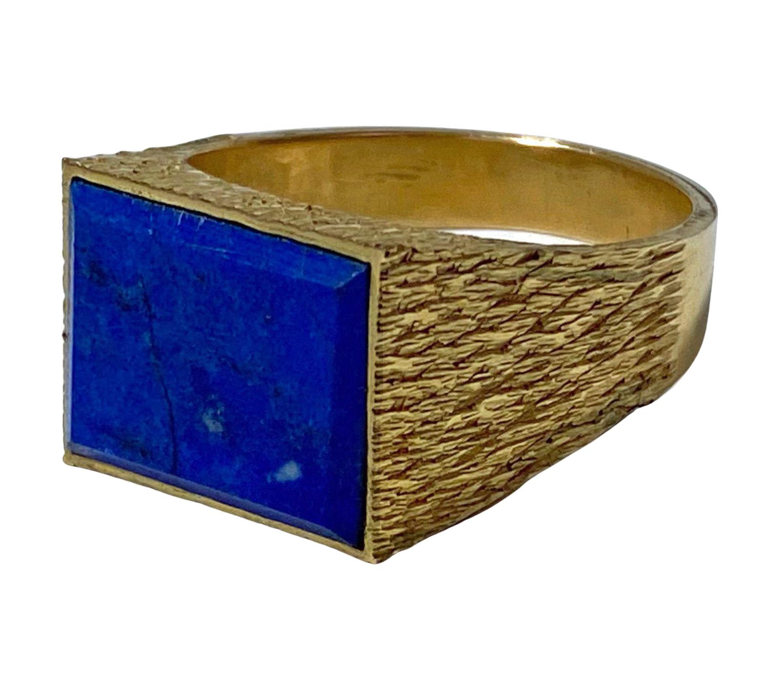 14kt yellow gold and lapis lazuli Ring, 1970s. Rectangular lapis ring set in 14K solid bark florentine finish shoulders polished gold shank. Ring front measures: 5/8 x 0.50 inches. Stamped 14K. Total Item Weight: 10.35 grams. Ring Size: 11.5