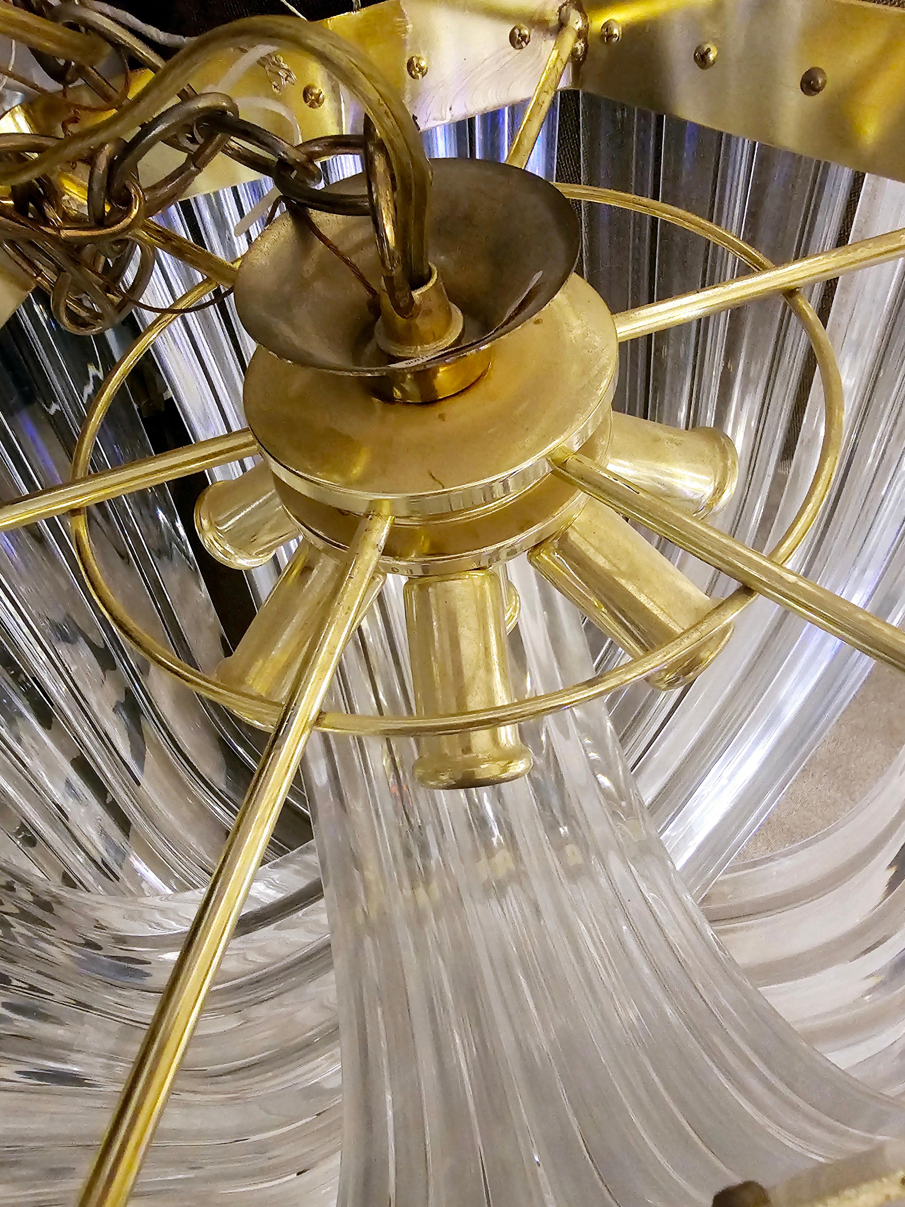 Exceptional extra large vintage Hollywood regency gold lucite ribbon loop chandelier. In the style of Carlo Nason this curved clear lucite prism chandelier is jaw dropping.
Looking for a lighting fixture that says, 'I'm fun, but also sophisticated?'