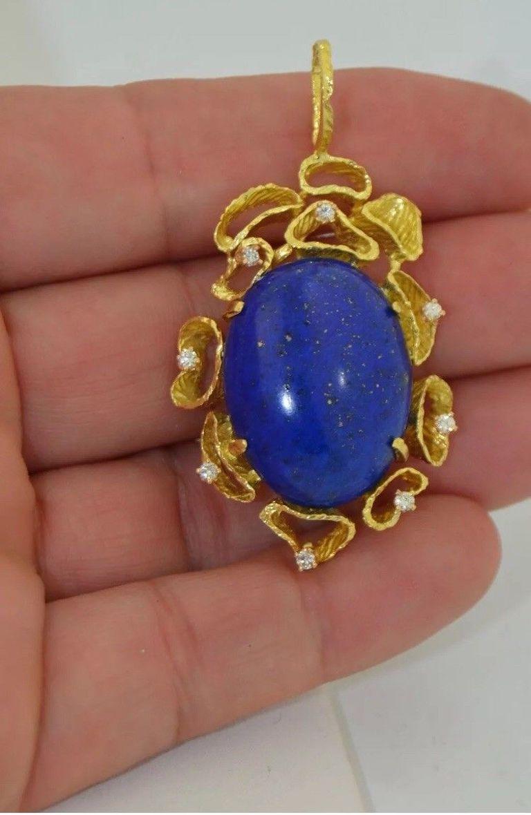 This is a lovely deep royal blue lapis lazuli cabochon necklace pendant.  The lapis possesses pyrite speckles. This lapis is an excellent example of a fine gem. It measures at roughly 25.5 carats.  The lapis is mounted and secured by prongs to the