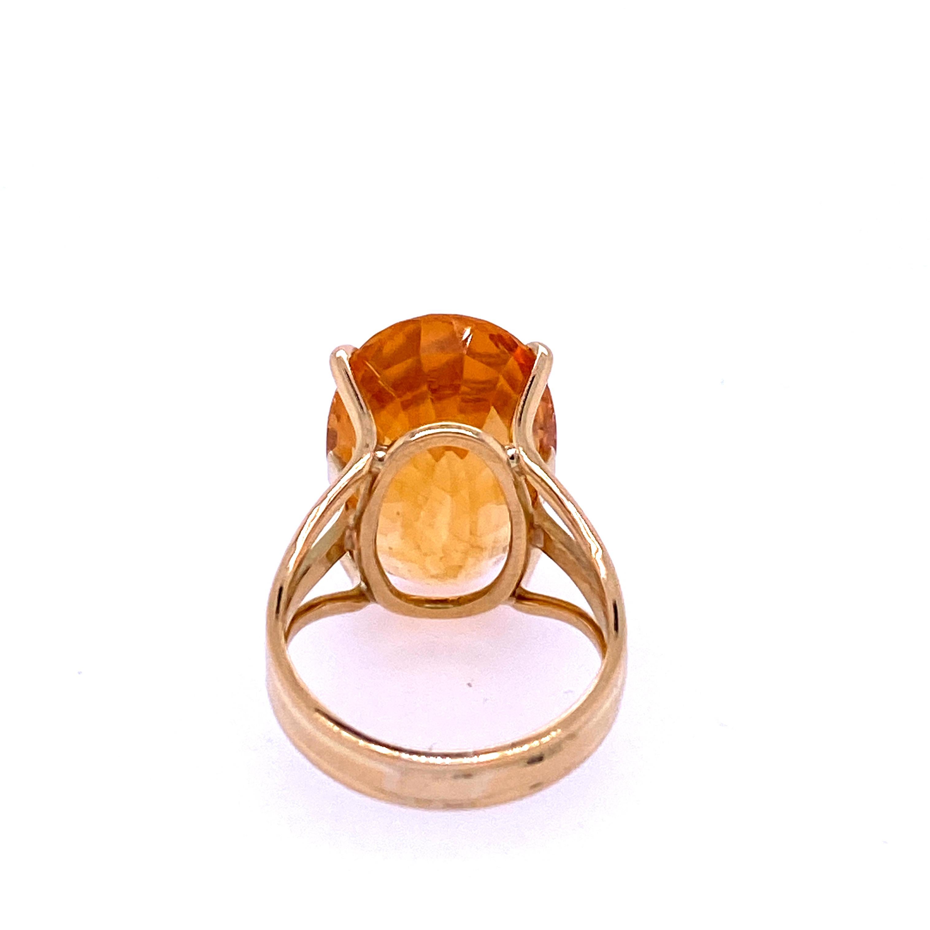 One 18 karat yellow gold (stamped 750) ring set with one 20.08 x 13.4mm oval golden citrine in a triple shak design.  The shank measures 11mm near the top of the ring and tapers to 4mm at the base.  The ring is a finger size 6.75. Circa 1970s