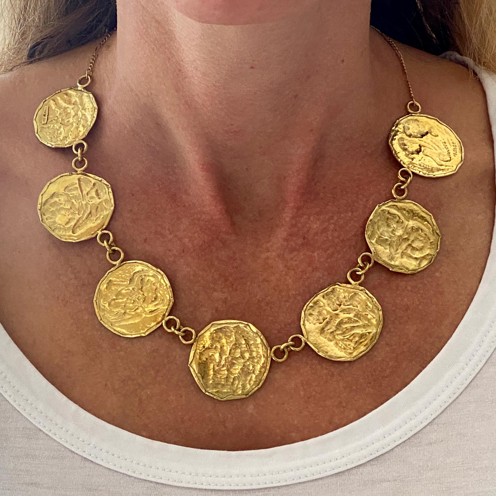 Fabulous vintage disc necklace fashioned in 18 karat yellow gold. The round textured discs measure 1.2 inches in diameter,  linked together the necklace measures 17.5 inches in length. 