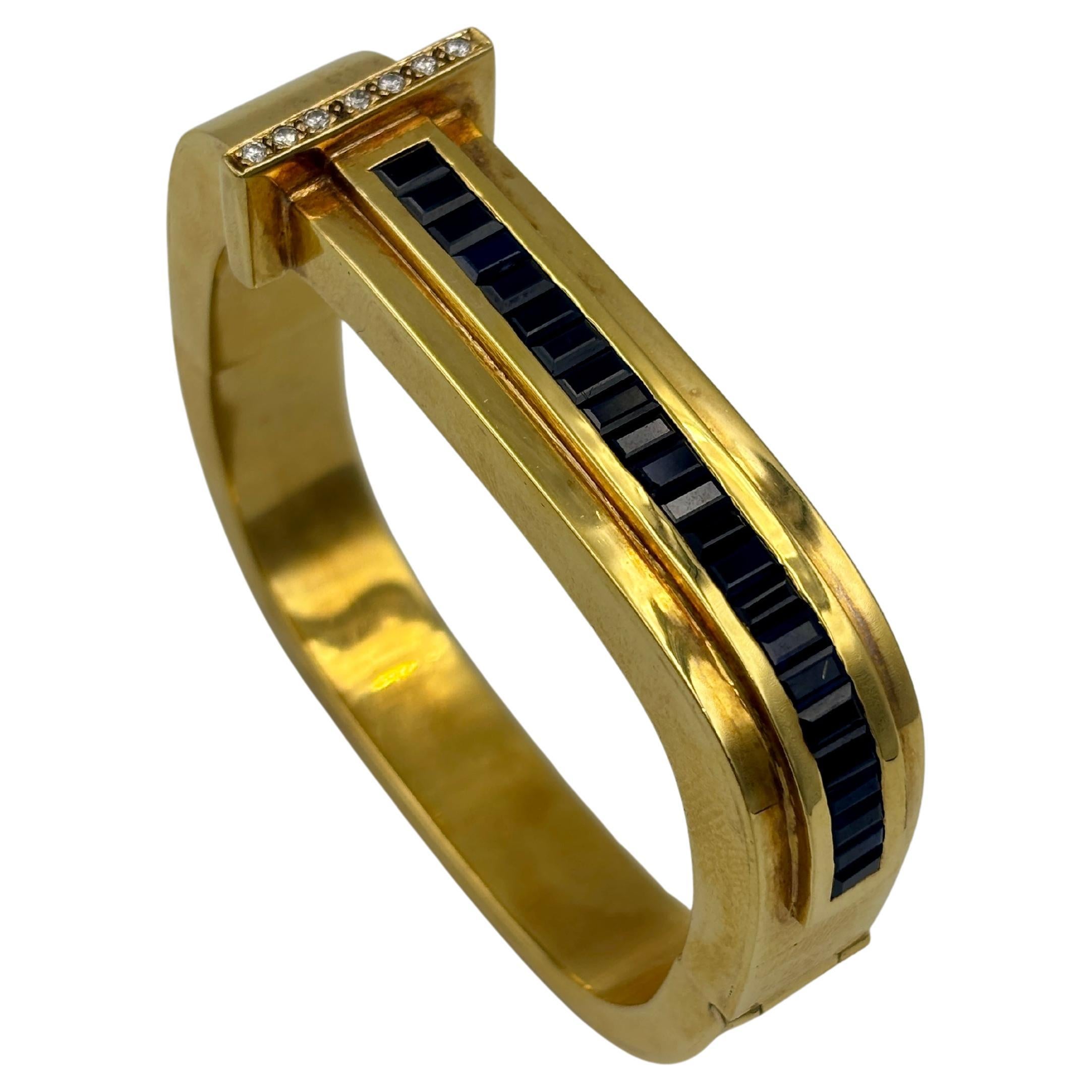 1970s 18k gold bangle with diamonds and approx 4 carats baguette cut sapphire For Sale