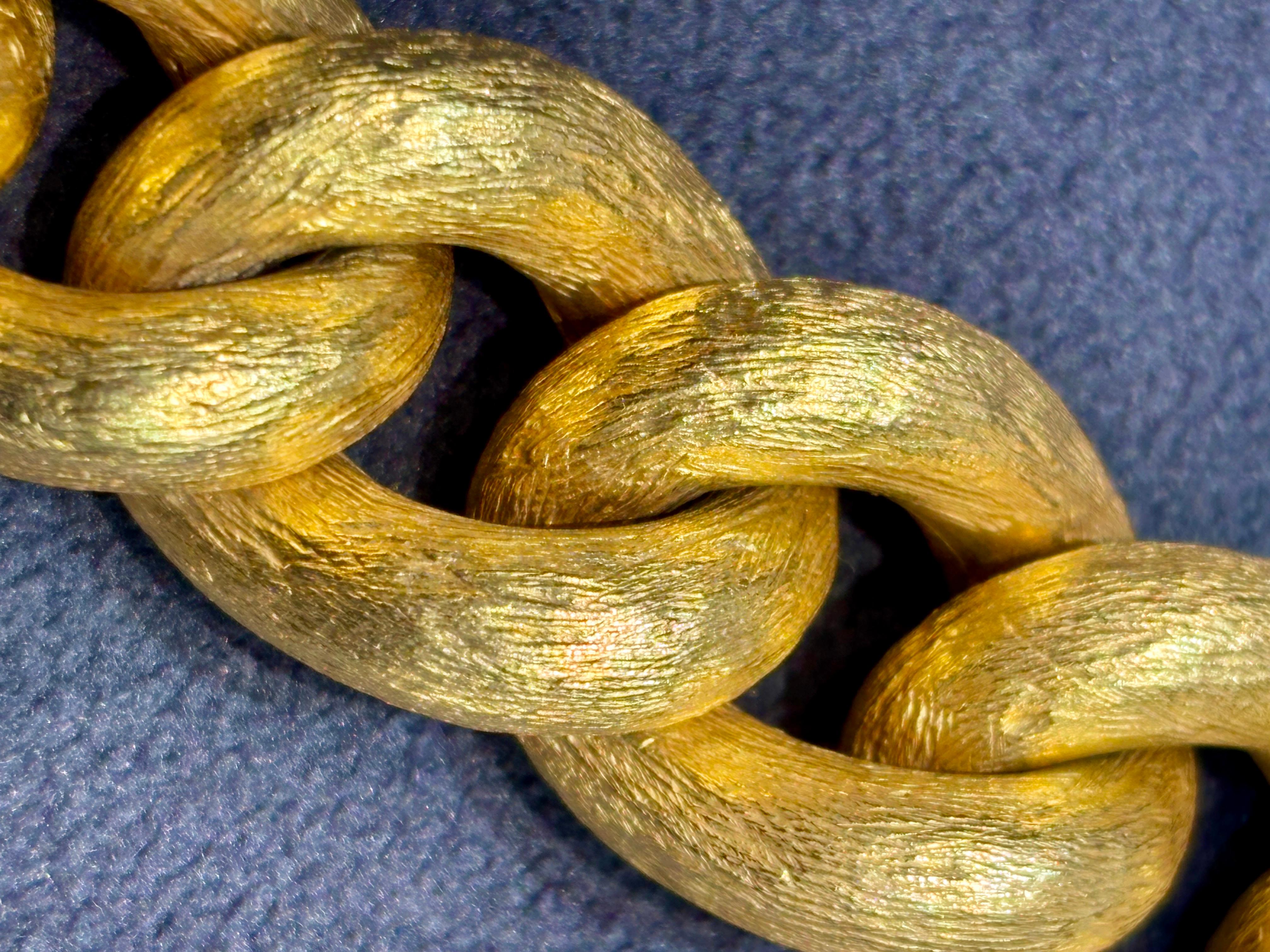 This beautifully hefty 1970s link bracelet is handmade from 18k yellow gold that has been engraved to give it a stunning texture.  