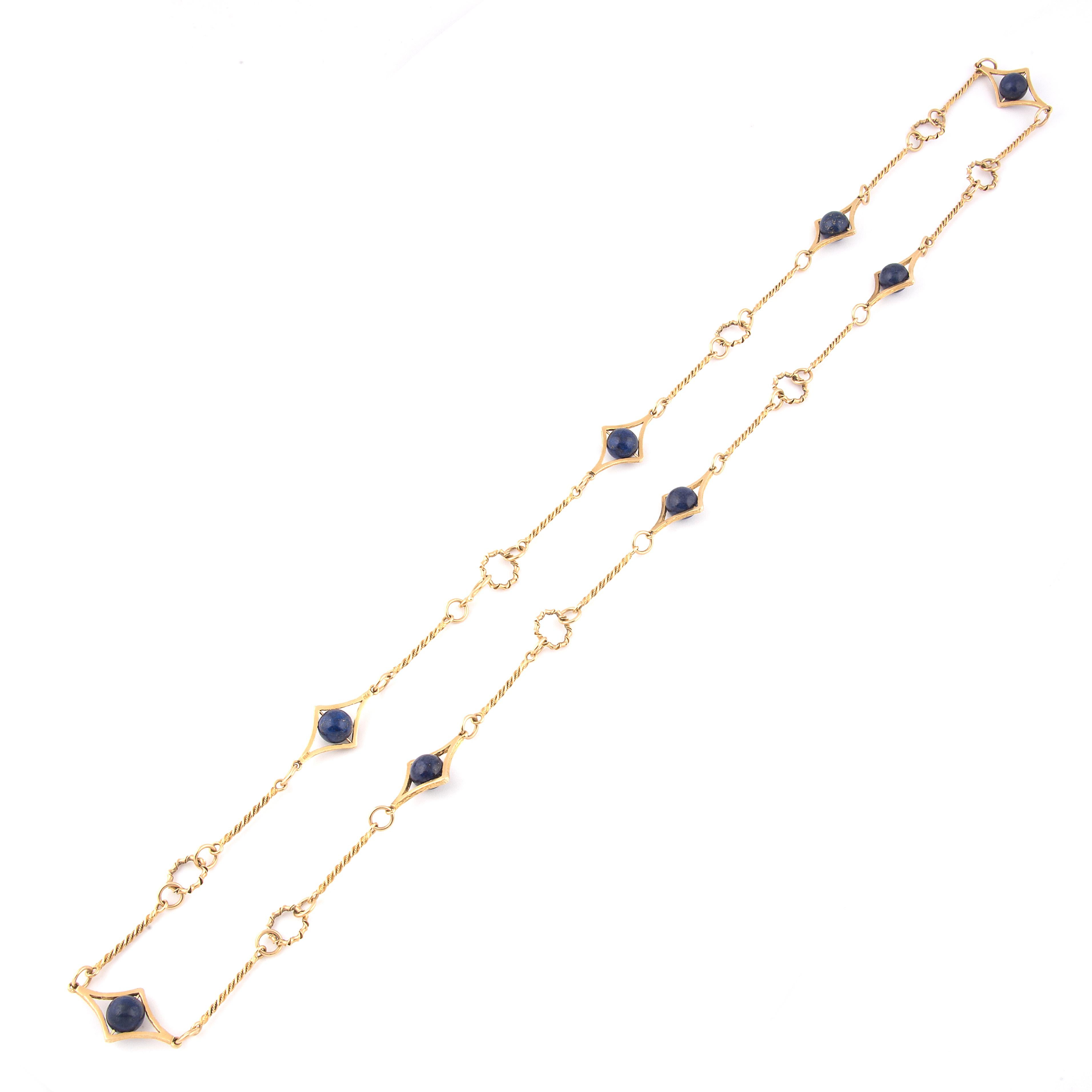 A stylish long 'sautoir' necklace, the 18k yellow gold twisted robe links connecting lozenge links set with Lapis Lazuli beads
Marked 750 and numbered B38
Italian, 1970's
