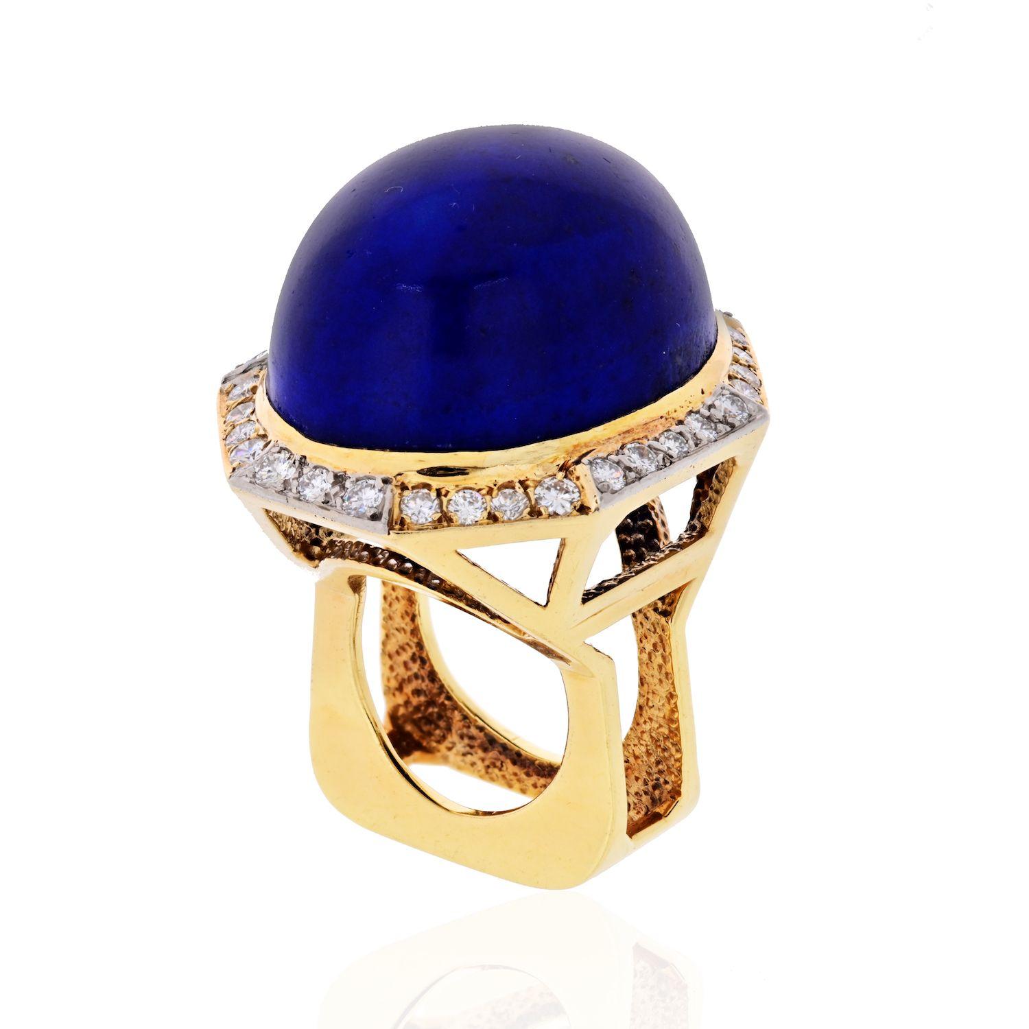 Add a proper splash of color to your dapper style with this lapis lazuli ring. Set atop a 18K yellow gold shank, this ring boasts a huge lapis lazuli cabochon and rolls out halo row of diamonds along all sides. 32 round cut diamonds graded G-H in