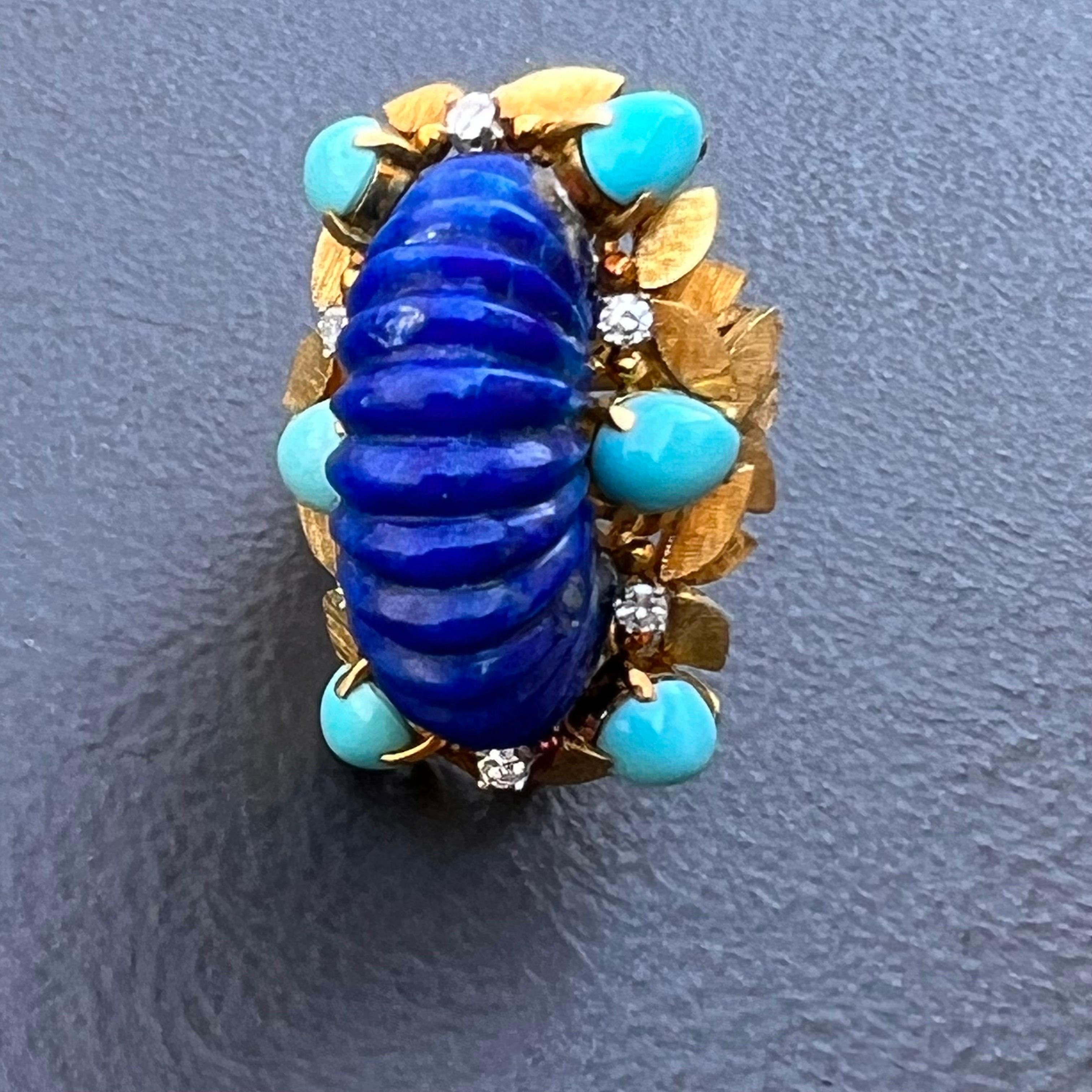1970's Spectacular cocktail ring  featuring  a huge carved lapis lazuli cabochon central stone surrounded by teardrop shape Persian turquoise and round brilliant diamonds . There are total of 6 prong set turquoise and 6 diamonds which are set on an