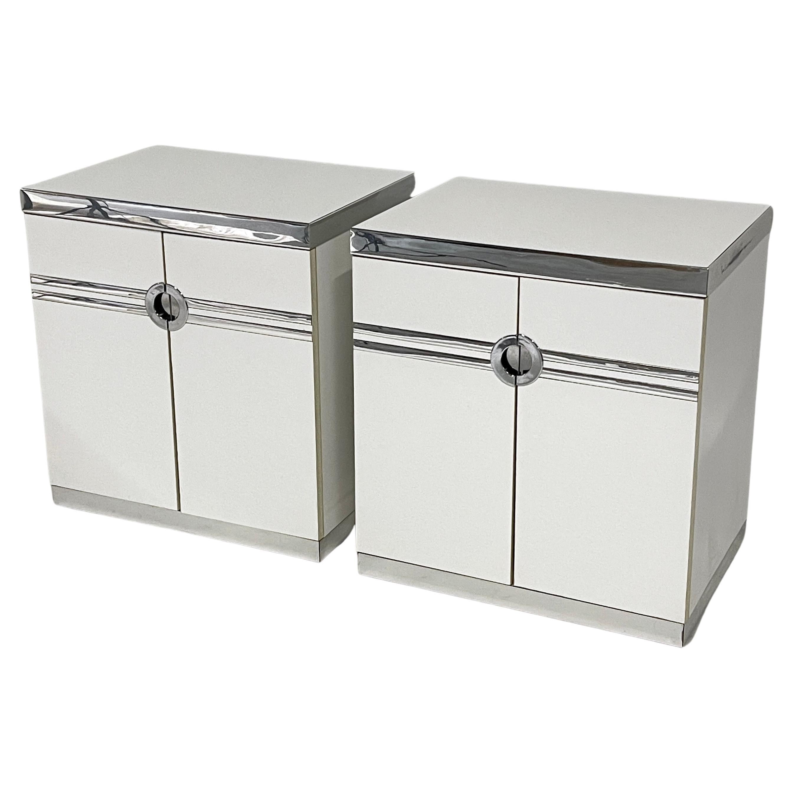 Stunning and sturdy pair of Pierre Cardin designed nightstands. Practical yet elegant and streamlined. Plenty of storage in these white and chrome postmodern nightstands that were designed with a nod to art deco design.