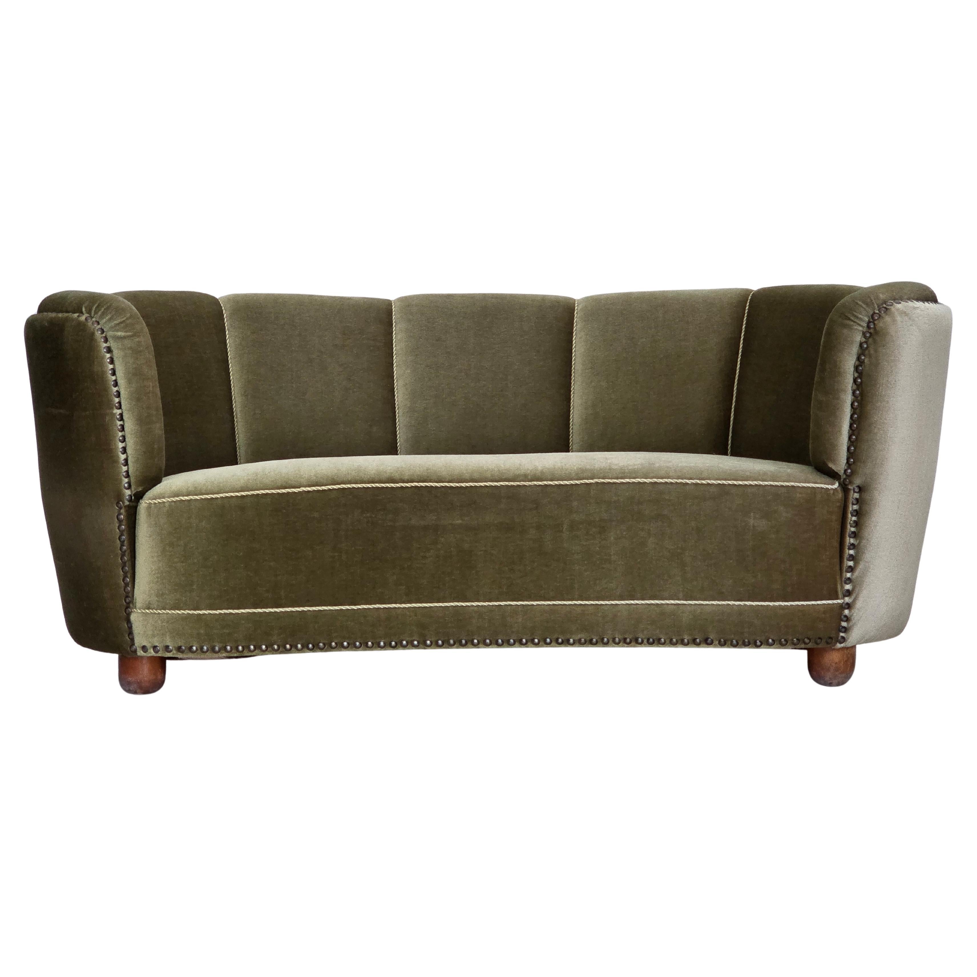 1970s, 2-seater Danish "Banana" sofa, green furniture velour, oak wood legs.