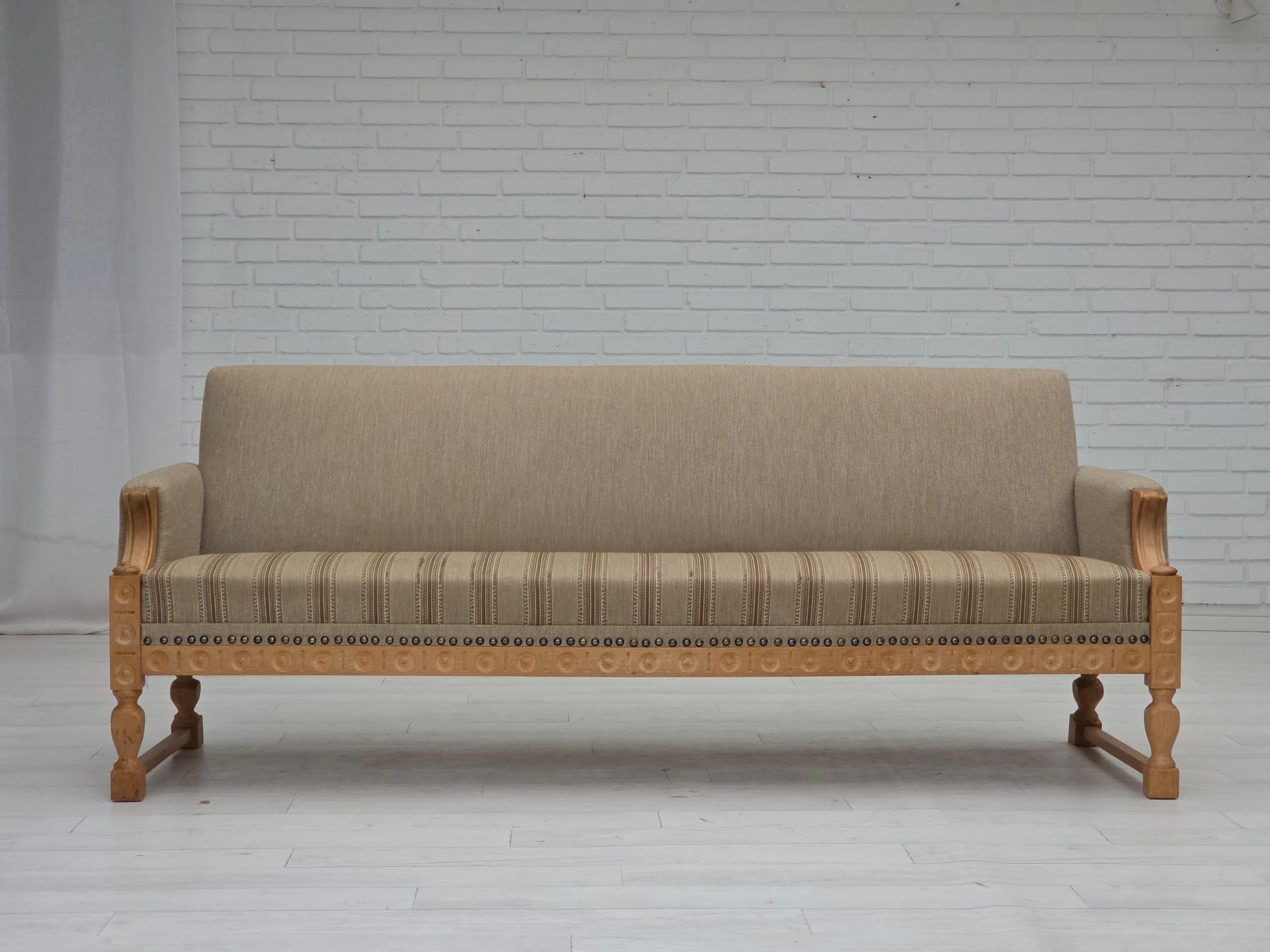 1970s, 3-seater Danish sofa. Original beige furniture wool, solid oak wood, springs in the seat. Original good condition: no smells, no stains and stable construction. Manufactured by Danish furniture maker in about 1970-75s. Original Scandinavian