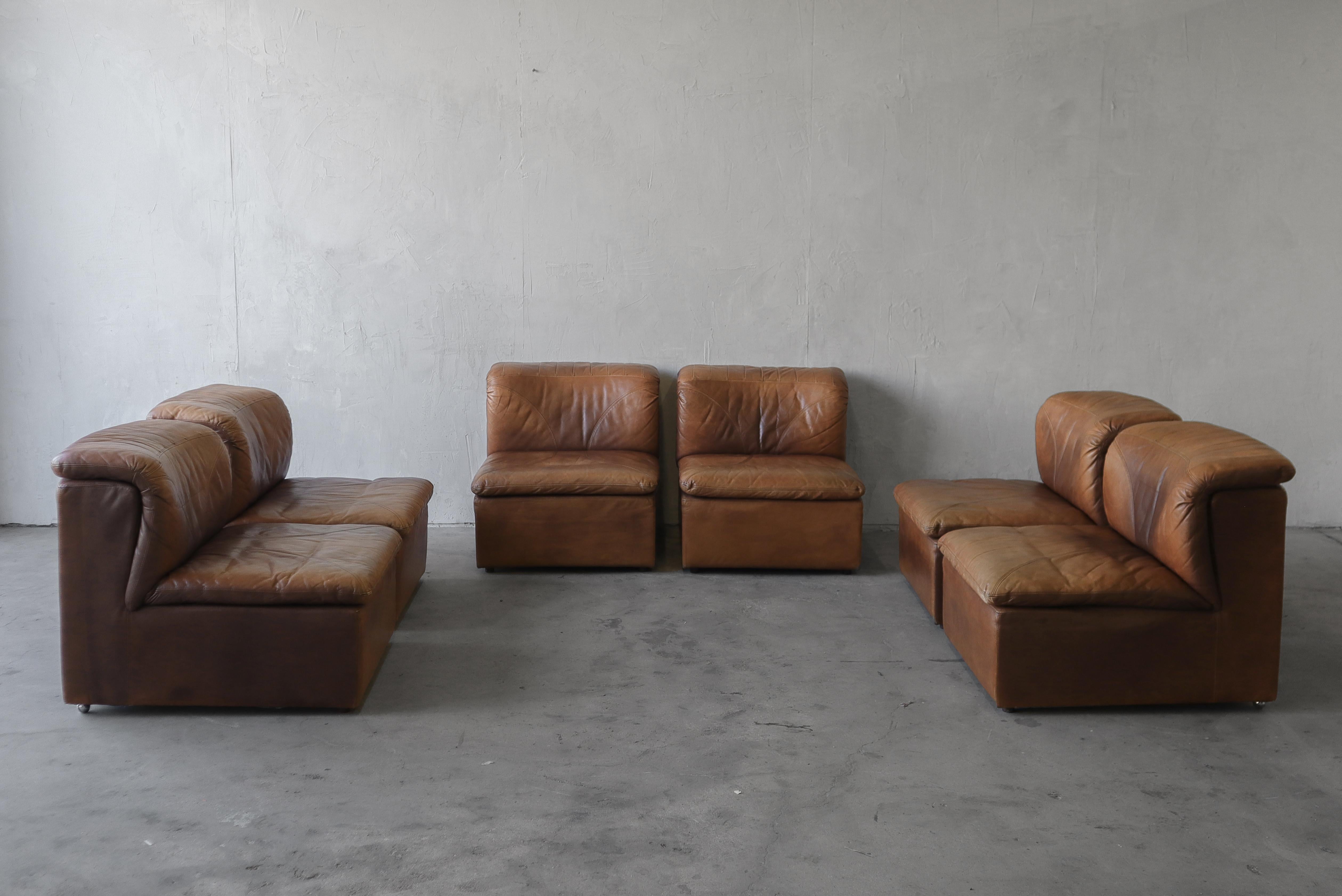 This 6-Piece, modular sectional sofa by De Sede is 1970s, patinated leather perfection. The options for this set are truly endless. Use it as one long sofa, 2 matching 3 seat sofas, a 4 seat sofa and 2 chairs. 6 chairs, and the list goes on.

To