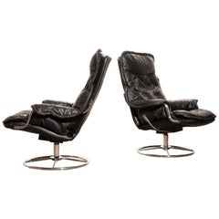 1970s, a Pair of Black Leather Swivel Chrome Steel Lounge Chairs, Sweden