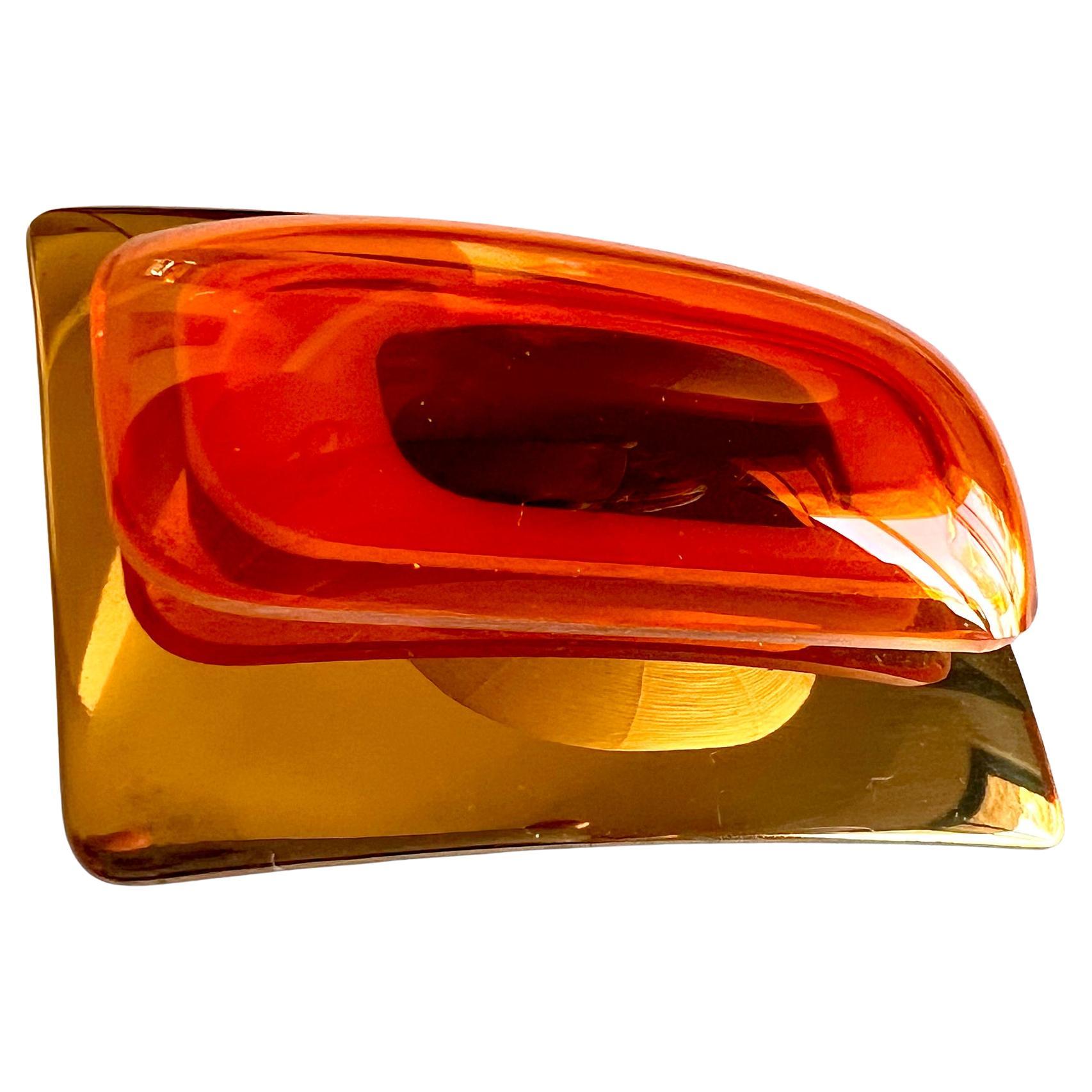 Vacuum-formed orange and maroon plexiglas belt buckle mounted on a plated brass buckle created by artist and sculptor Aaronel deRoy Gruber, circa 1970's.  Buckle measures 2.25