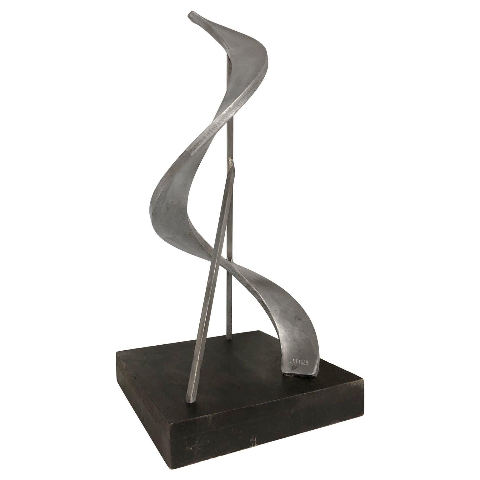 Abstract aluminum sculpture on square wooden base, signed 
