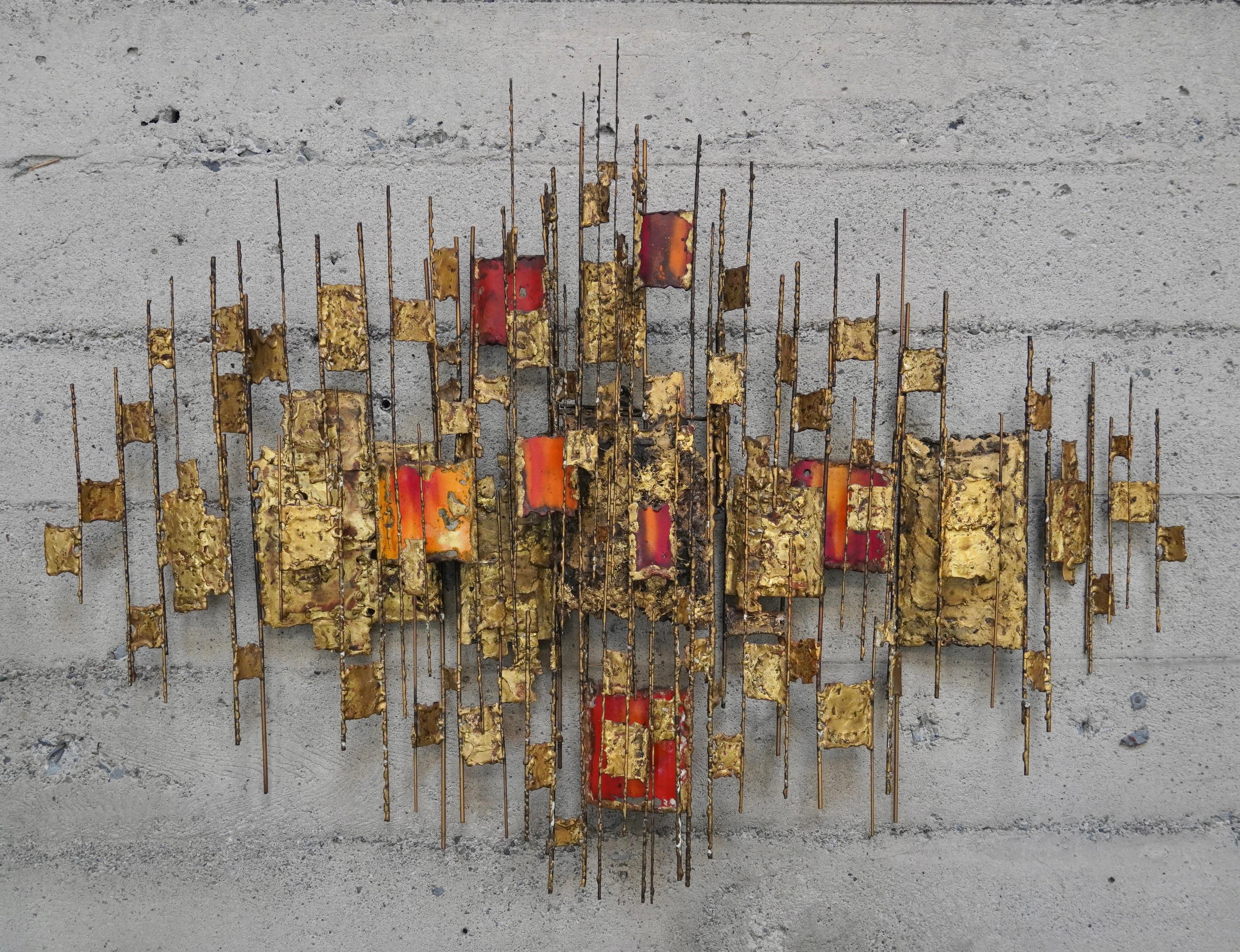 Multi colored enamel abstract wall sculpture in brass by California artist Donald Buby. Constructed of various sizes of brass rods and enamel coated brass elements welded throughout the sculpture creating different levels of visual scale and