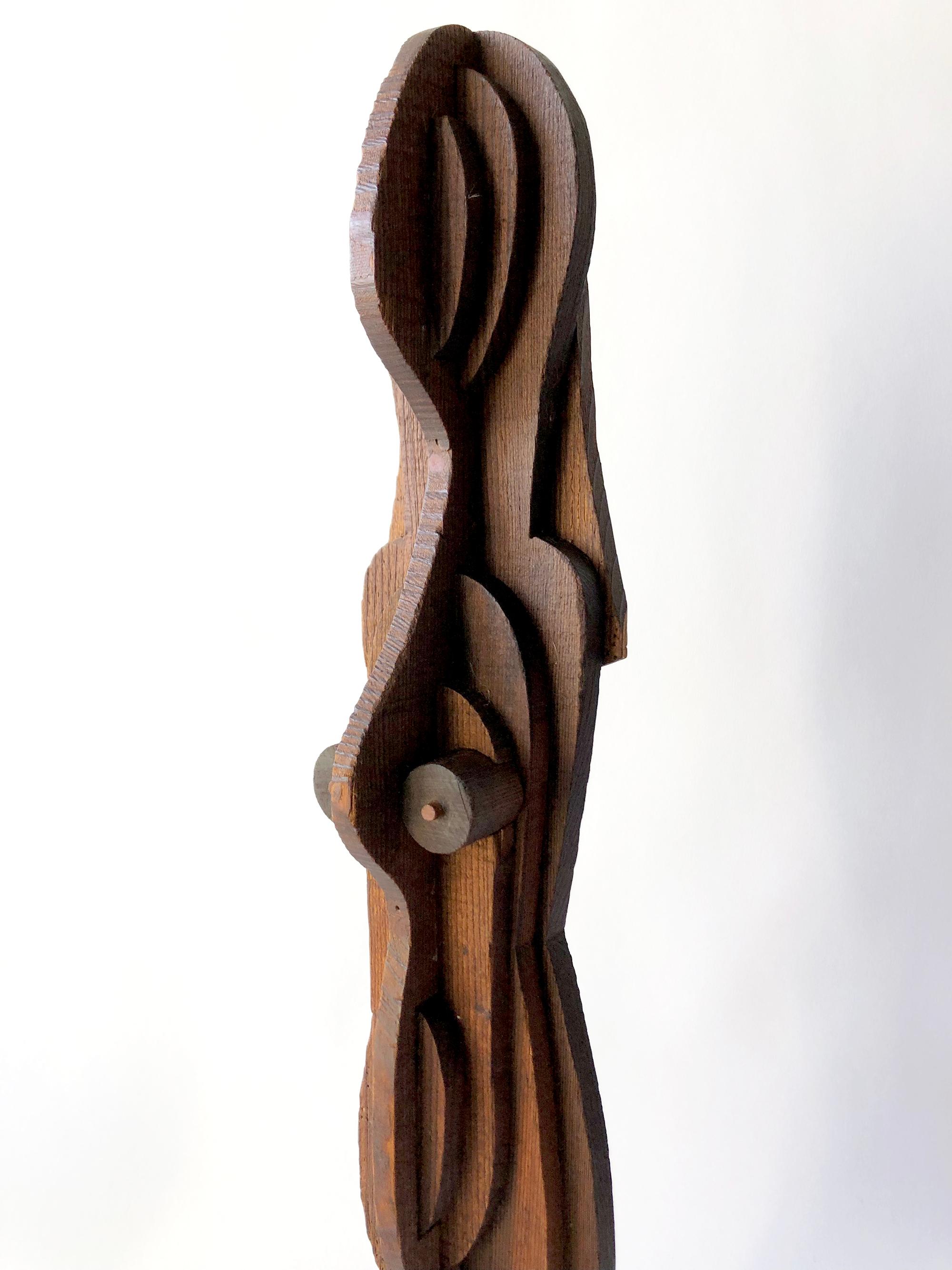 1970s abstract dimensional layered wood female sculpture in the style of Ernest Trova. Sculpture measures 24