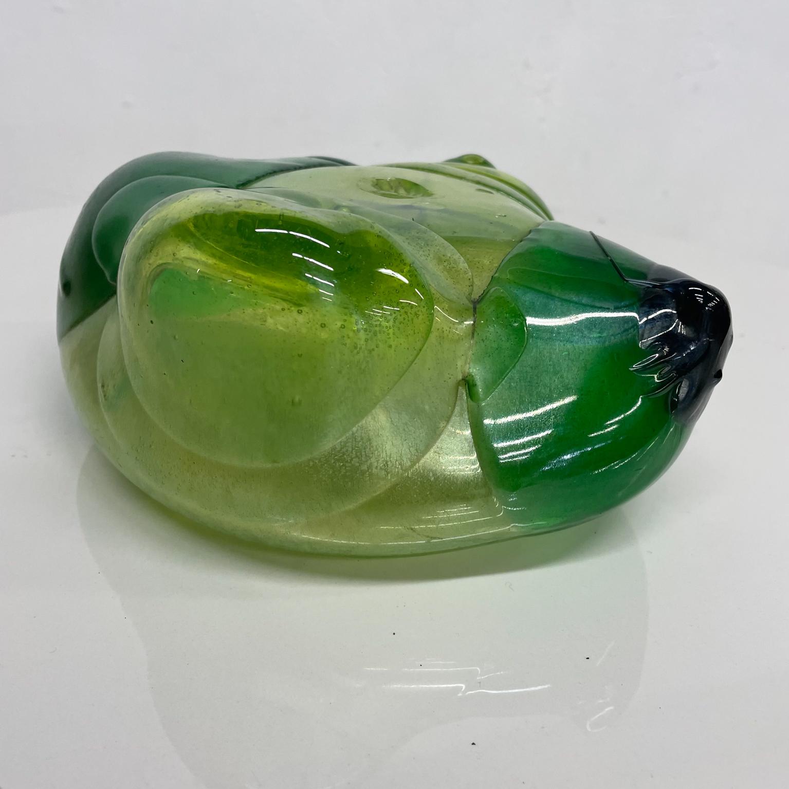 Glass sculpture
1970s abstract green glass sculpture modern free form expression 
Measures: 7.38 W x 8.5 D x 3.75 H
Preowned original unrestored vintage condition.
Refer to images provided.