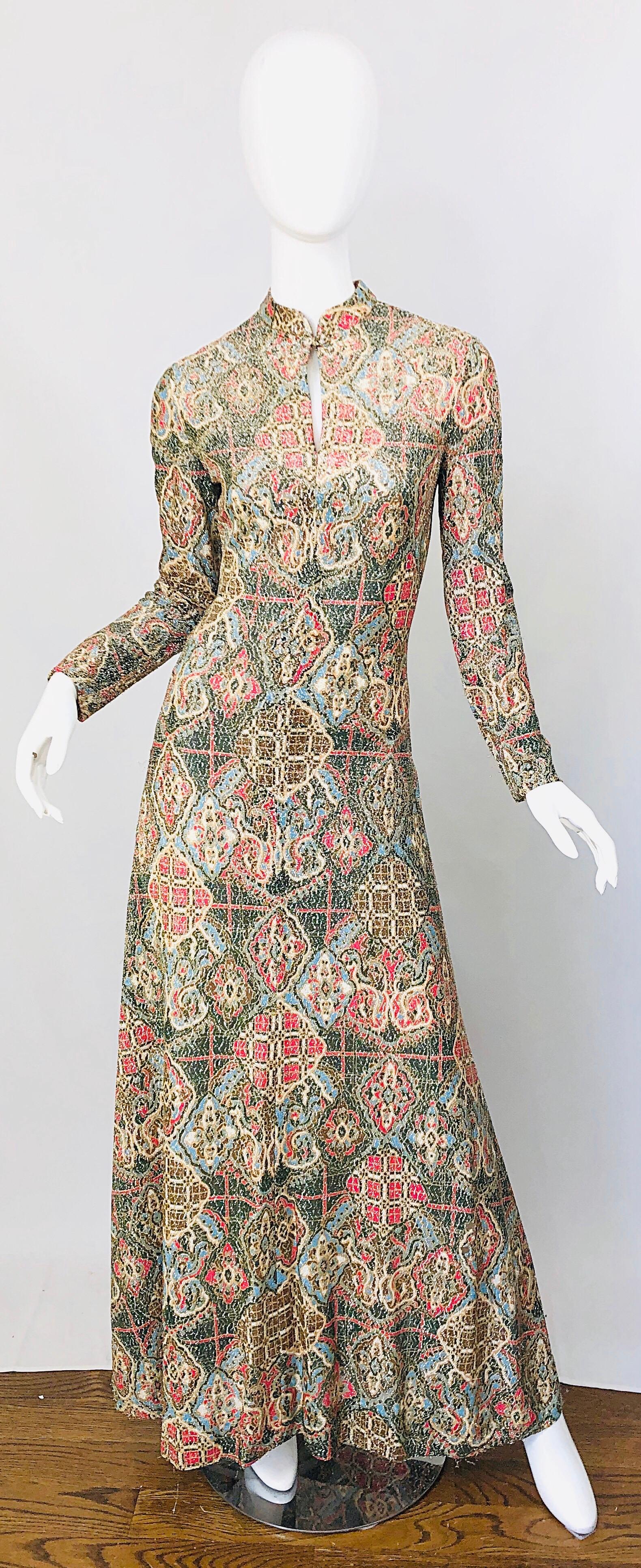 Amazing 1970s ADELE SIMPSON lurex silk metallic baroque ethnic print Cheongsam style gown / maxi dress ! Features warm colors of red, blue, green, and brown throughout. Fabric covered button at top center neck with a slight peek-a-boo slit. Fully