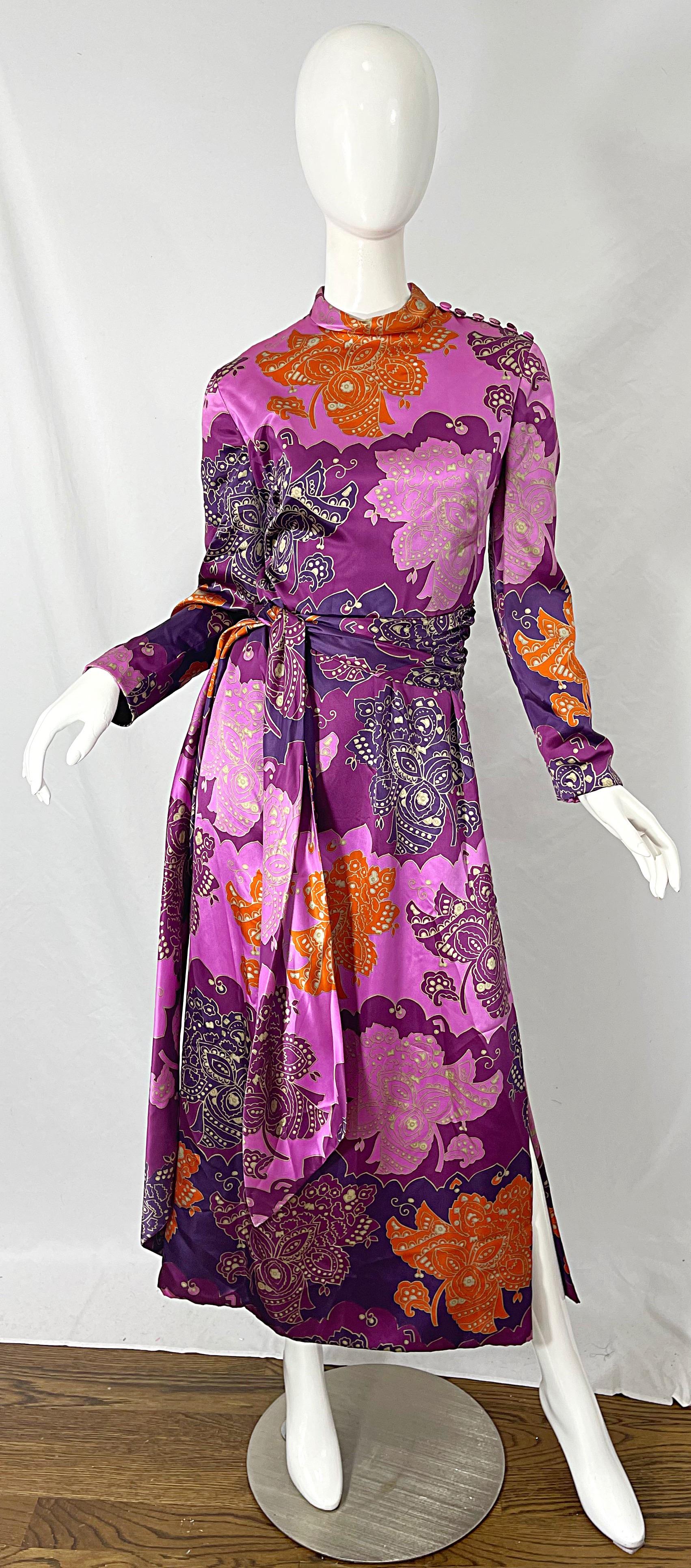 Incredible vintage 1970s ADELE SIMPSON paisley print silk maxi dress and sash belt ! Features vibrant warm colors of purple, lavender, orange and white throughout. Mock buttons up the side skirt and on the left shoulder. Hidden metal zipper up the