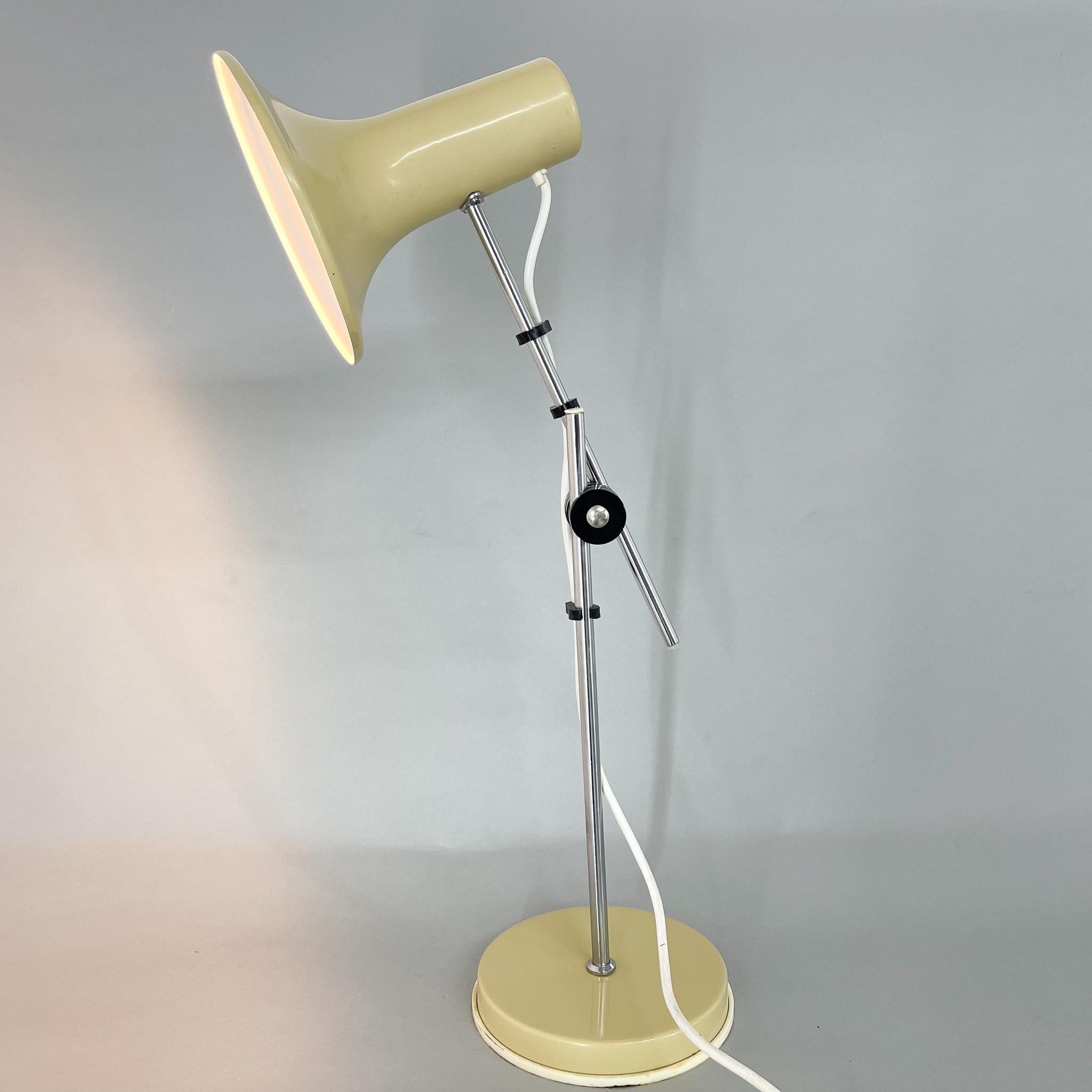 Vintage table lamp with adjustable arm and lampshade. Made of chrome and metal, produced in Hungary (see label).