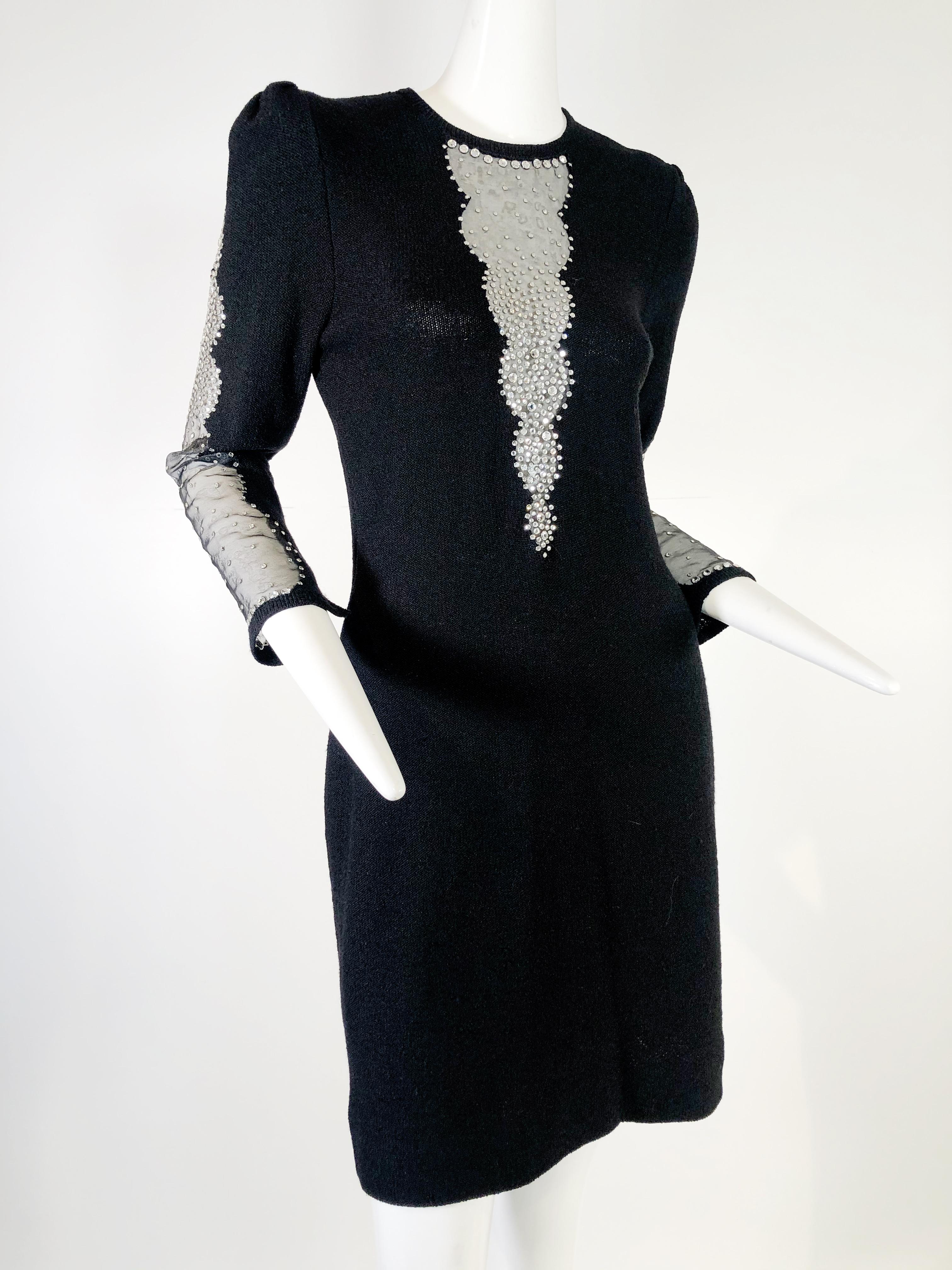 1970s Adolfo black wool blend knit cocktail dress with sheer plunging panels at neckline and sleeve.  Beautifully embellished with glittering rhinestones.  Zipper back w/ original hemline. Some discreet snags on black knit. 