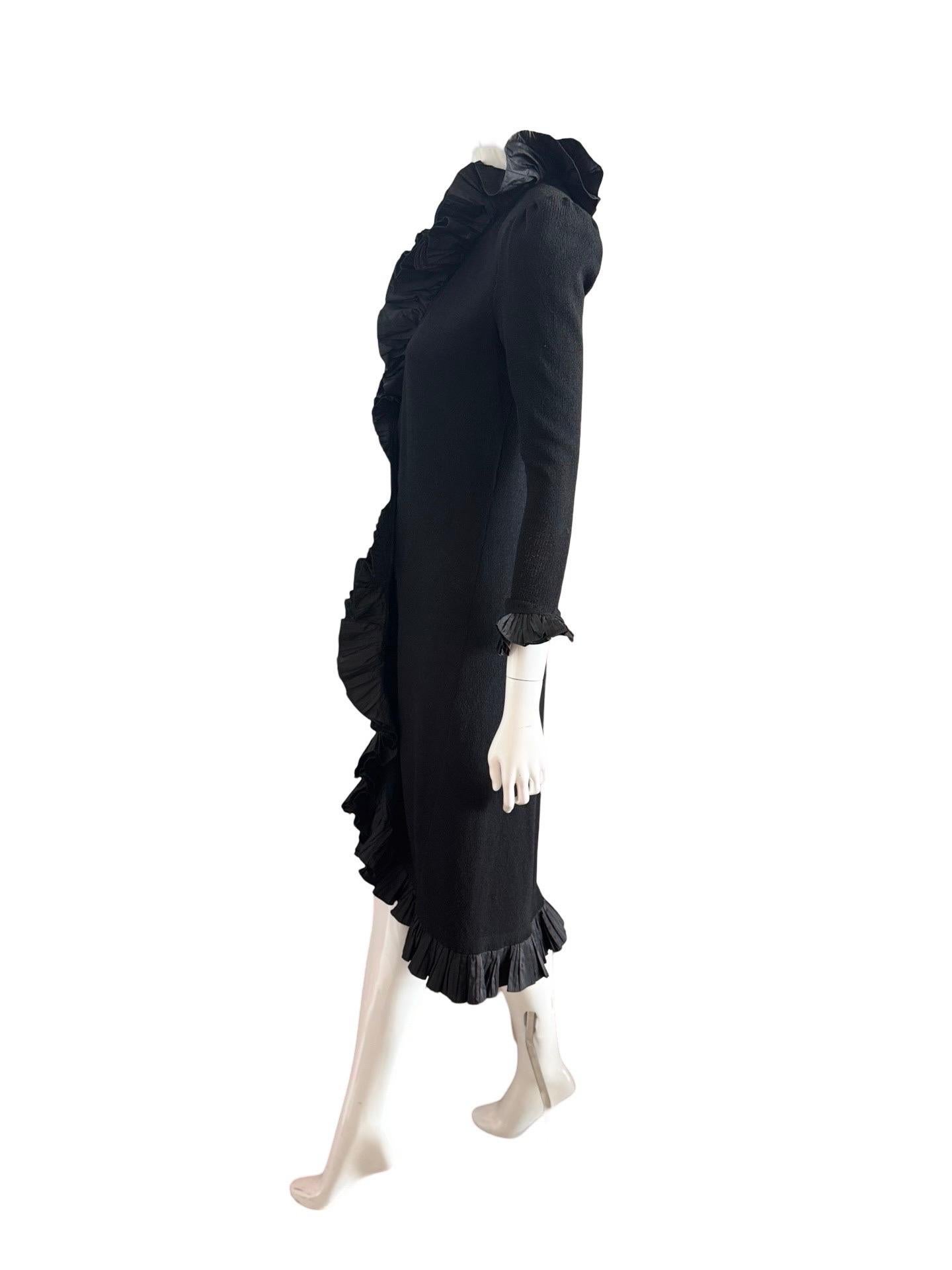 1970s Adolfo New York. We love the drama that this sweater/coat provides while also being comfortable.  It closes with a hidden long velcro piece which was likely added afterwards and could be modified to your preference. Slight puff at the shoulder
