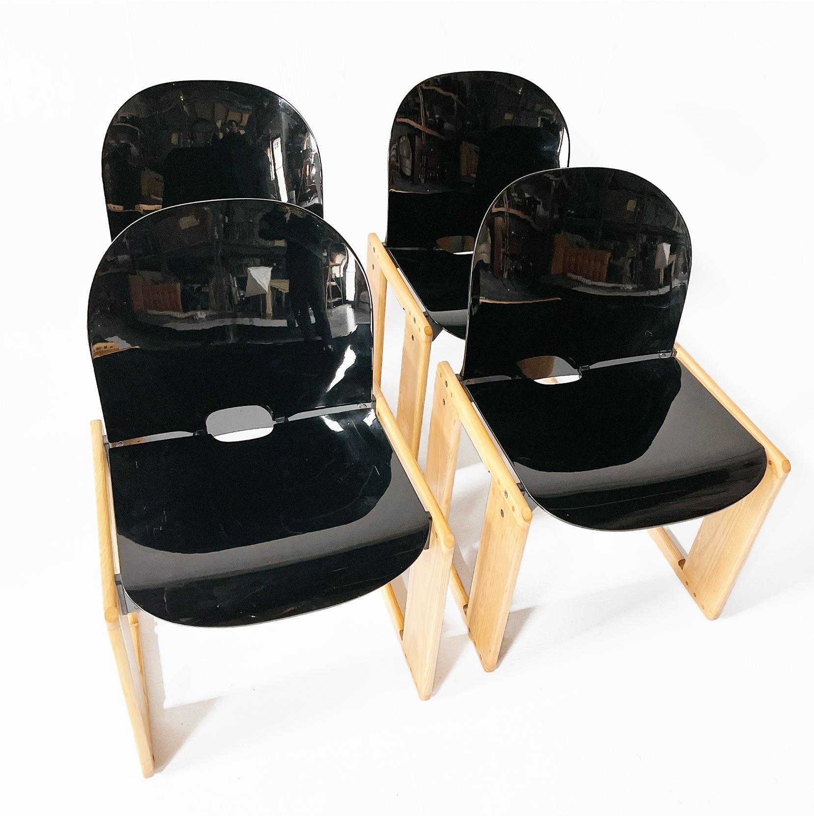 Afra and Tobia Scarpa for B&B Italia, set of four ‘Dialogo’ dining chairs, the seat and back rest in a rich chocolate brown fiberglass and supported on angular oak wood frames. The ‘Dialogo’ dining chair was designed by Afra and Tobia Scarpa in the