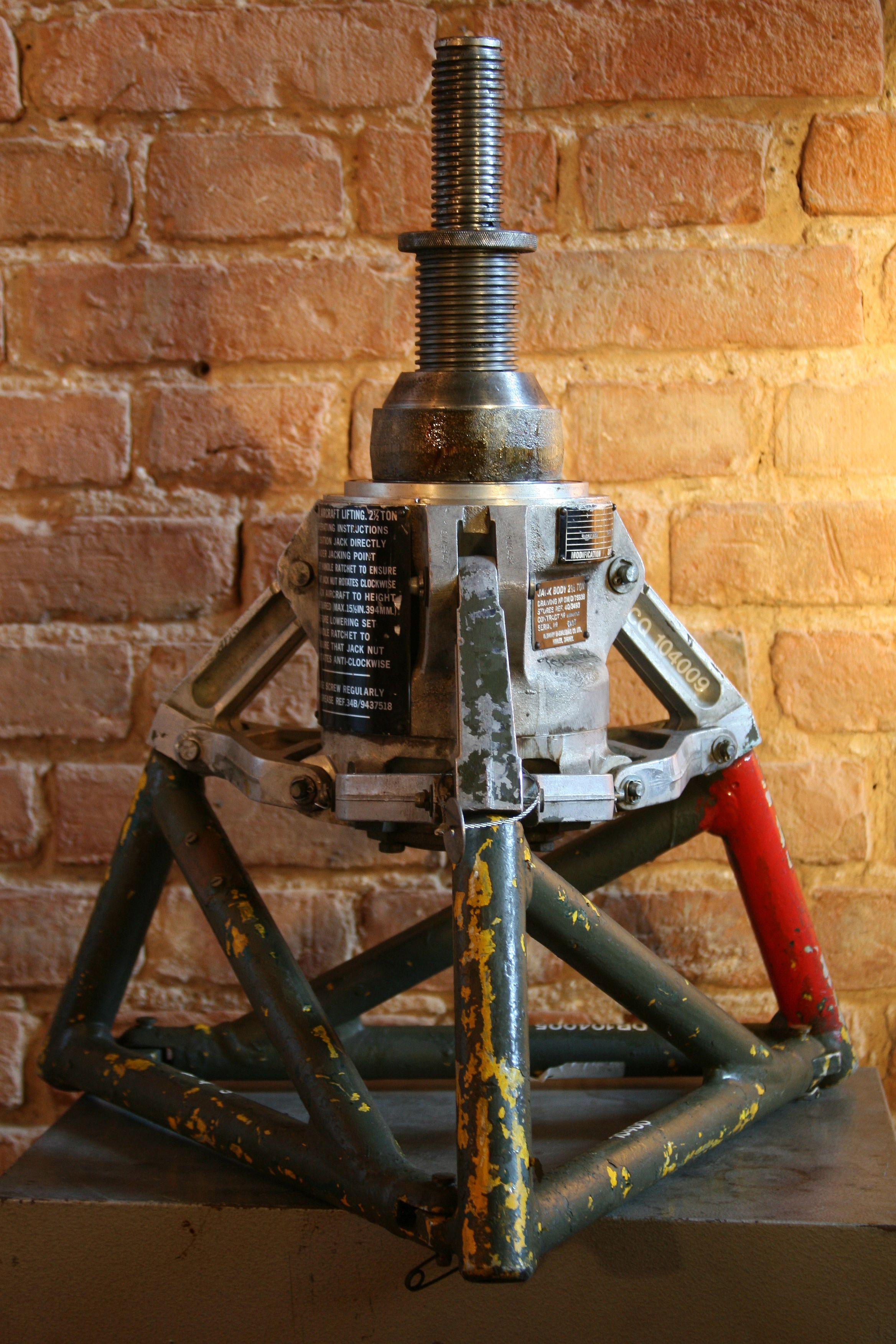The original air hydraulic jack with a lifting capacity of 2.5 T, used by the Air Force of the United Kingdom.
Manufacturer: Oldbury Engineering Co. L.T.D.
Production year: 1978

Construction:
Jack’s body and fixing brackets are made of