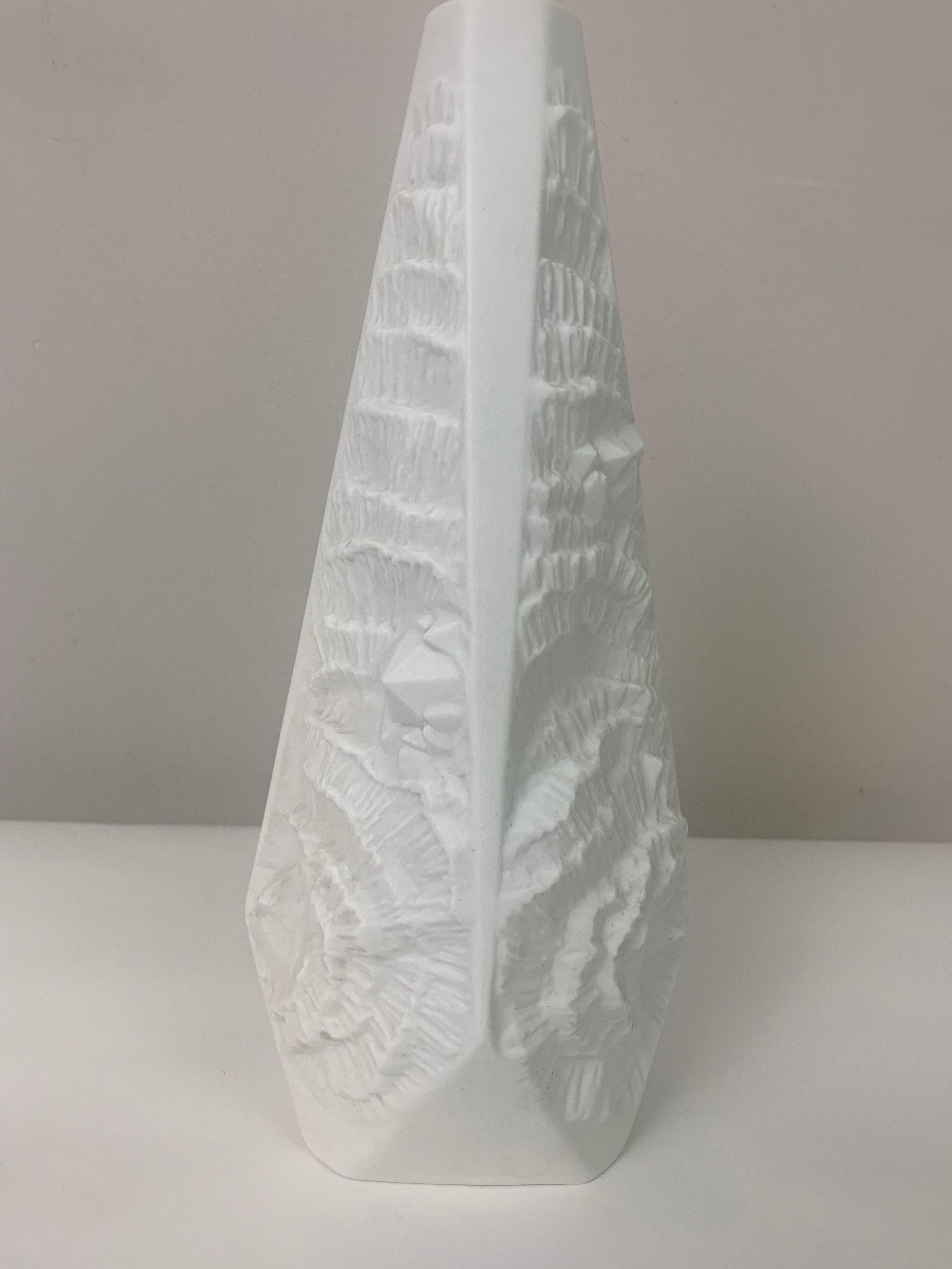 An unusual pyramid op art white bisque matte porcelain vase with an abstract relief fossil design on four sides. Manufactured by Alka Kunst Kaiser Porcelain in West Germany during the 1970s. Inscribed on the base with the design number 274 with the