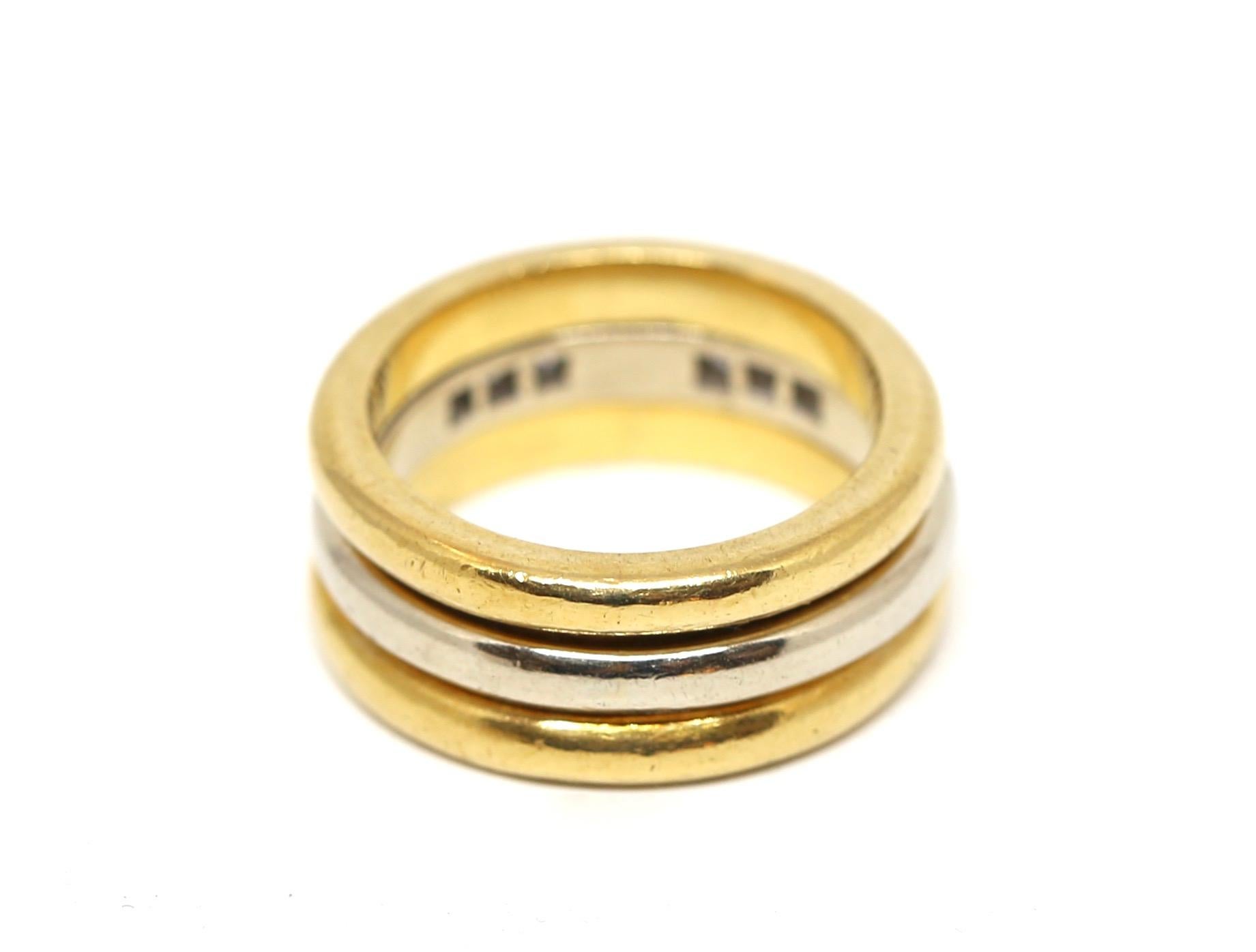 Minimalist 18k yellow gold and 18k white gold interlocking ring set accented with 6 diamonds designed by Aldo Cipullo dating to the late 1970's. Ring set best fits a US 5.5 and can be resized by a jeweler. Ring is marked 'A.Cipullo' and '18k' and is