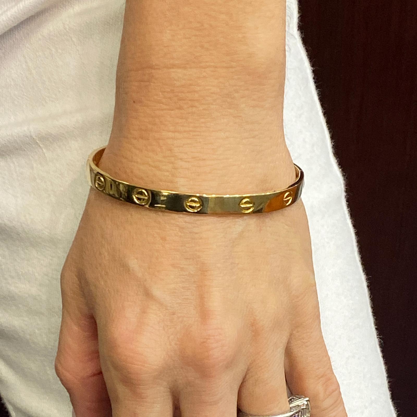 Original Authentic Cartier Love Bracelet by Aldo Cipullo circa 1970. The Love bracelet is crafted in solid 18 karat yellow gold, and measures 19cm in circumference (size 19). The bracelet comes in a Cartier pouch, but no screw driver. Signed Aldo
