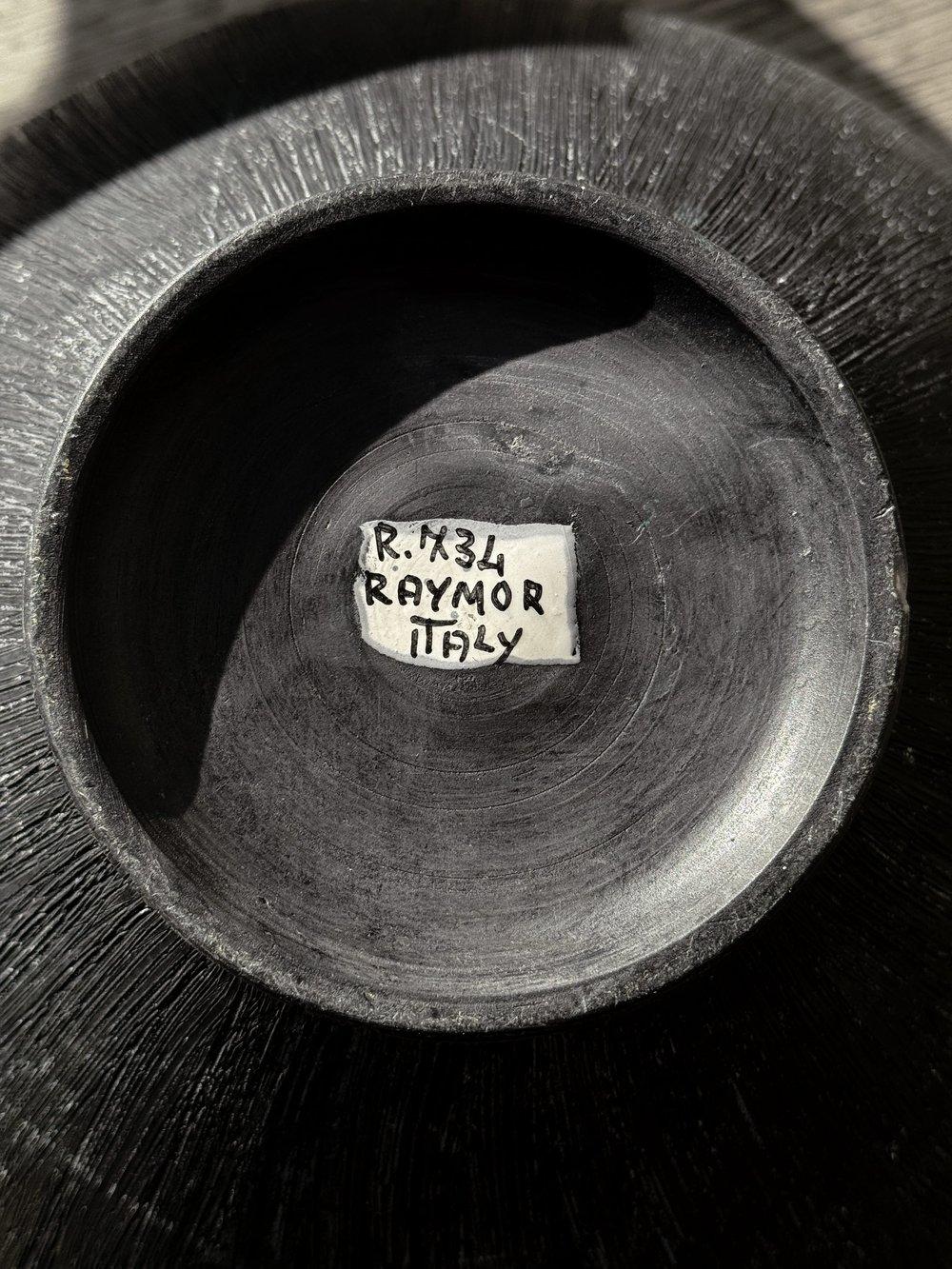 The Alvino Bagni for raymor sgraffito pottery vase, crafted in the 1970s, this sizable mid-century modern vase features a striking matte black glaze adorned with intricate incised sgraffito decorations. Its shoulder is embellished with circular