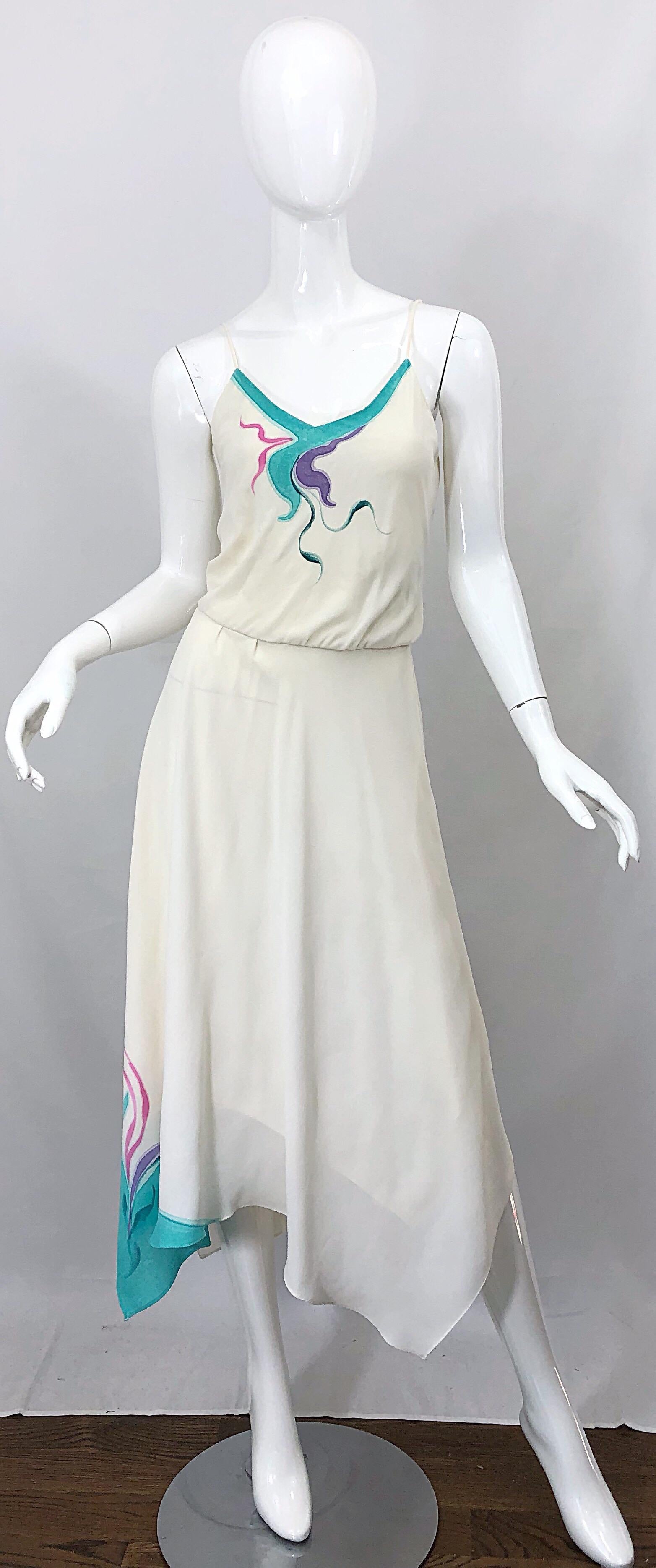 Amazing late 1970s handkerchief hem ivory, turquoise blue, pink and purple swirl print dress! Features a swirl screenprint on the bodice and on the right side of the hem of the skirt. Elastic waistband can stretch to fit an array of sizes. Great for