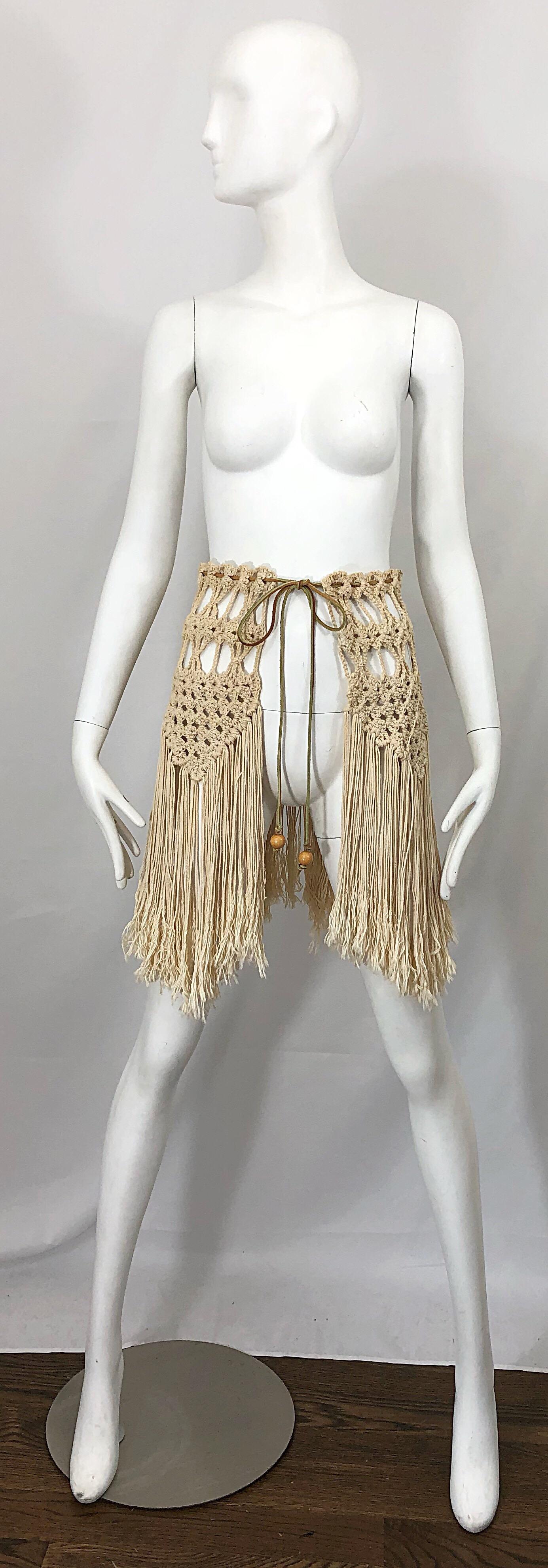 Amazing 1970s crochet khaki and brown boho crochet belt or capelet! Features fringe that dangles from the cotton crochet. Brown leather suede cord at waist with two beads at each end. Can be worn as a belt or capelet. Both ways are equally as chic.