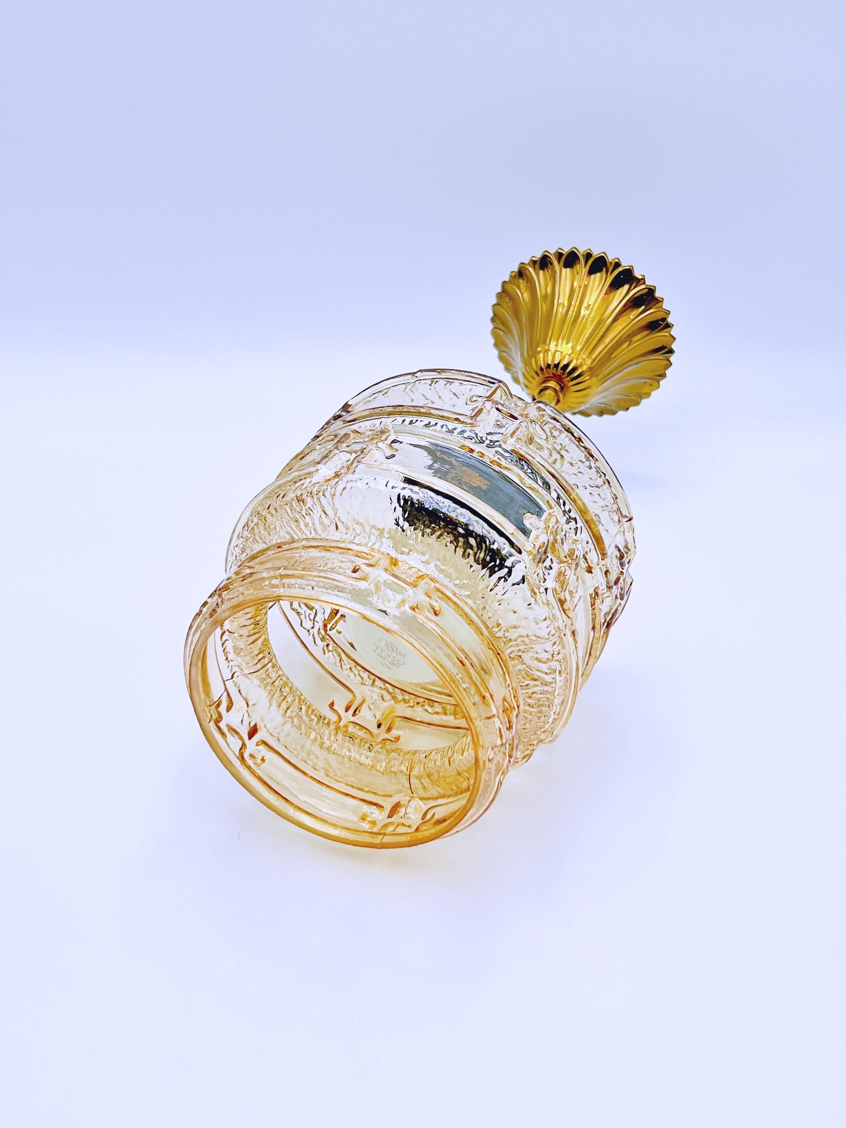 Primitive Scandinavian mid-century modern style lamp / pendant light crafted from amber glass and brass/metal with geometric patterns.

From the 1970s, it is still in very good vintage condition, with perfect functionality tested and only normal