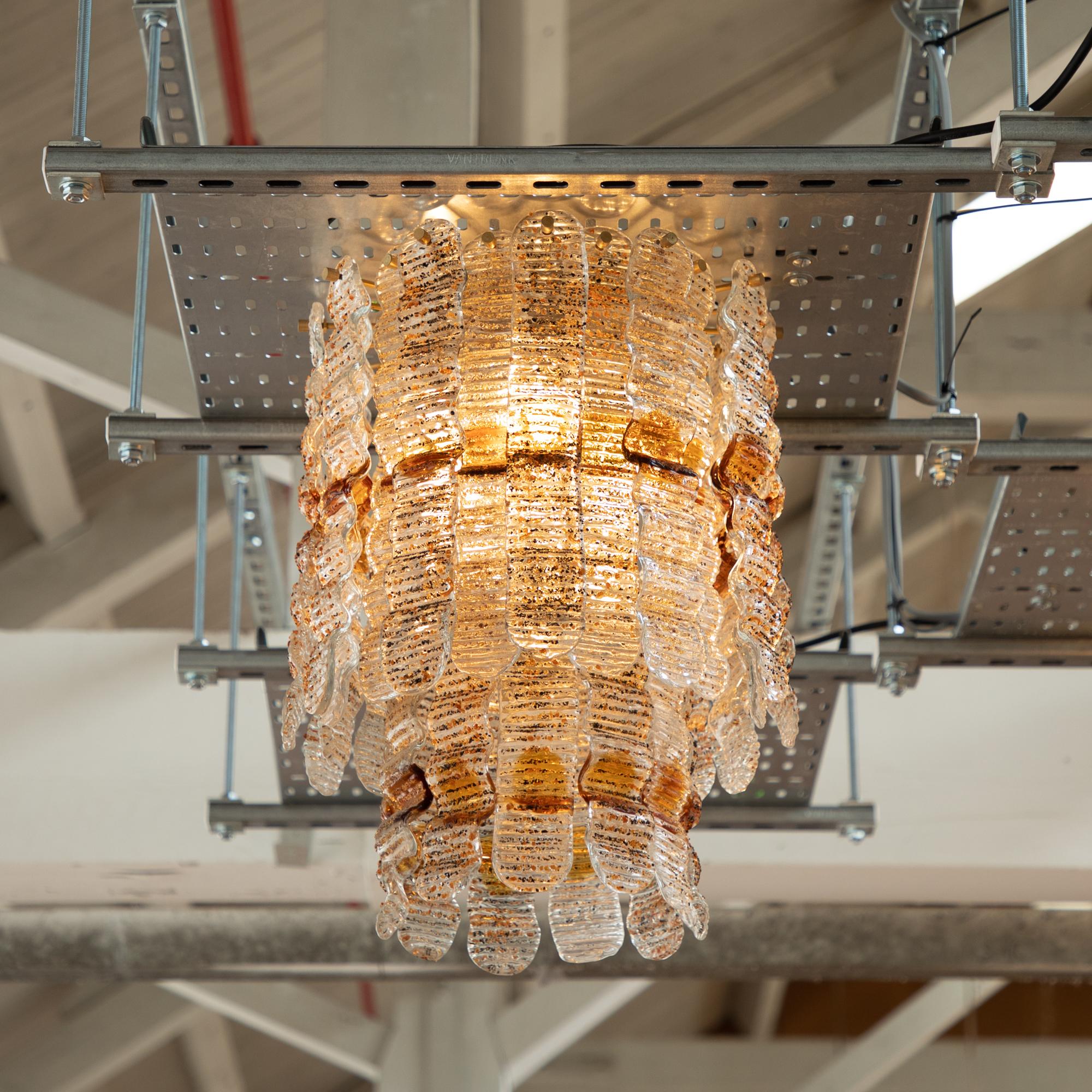 Stunning two-tier chandelier. 10 small and 24 large Murano glass plates. The soft curvaceous plates have an opaque textured finish with amber glass details where the plates dip and undulate. The overall effect once hung is a soft and mesmerising