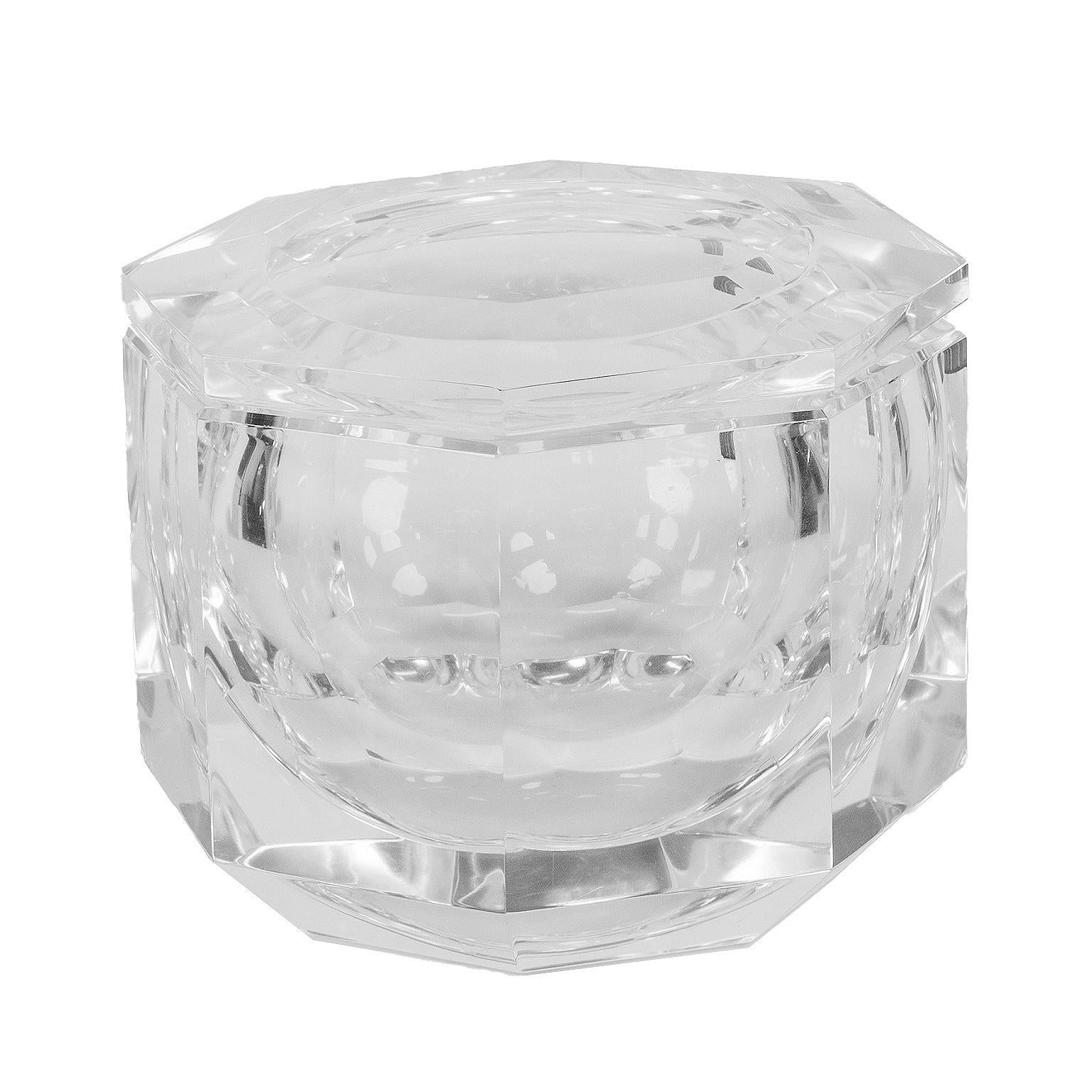 This is a beautiful clean sculpted ice bucket that looks great anywhere you place it. 
Constructed with thick lucite this octagonal  piece has a faceted top that swivels to open. It is in excellent condition with very minor ware. It doesn’t appear