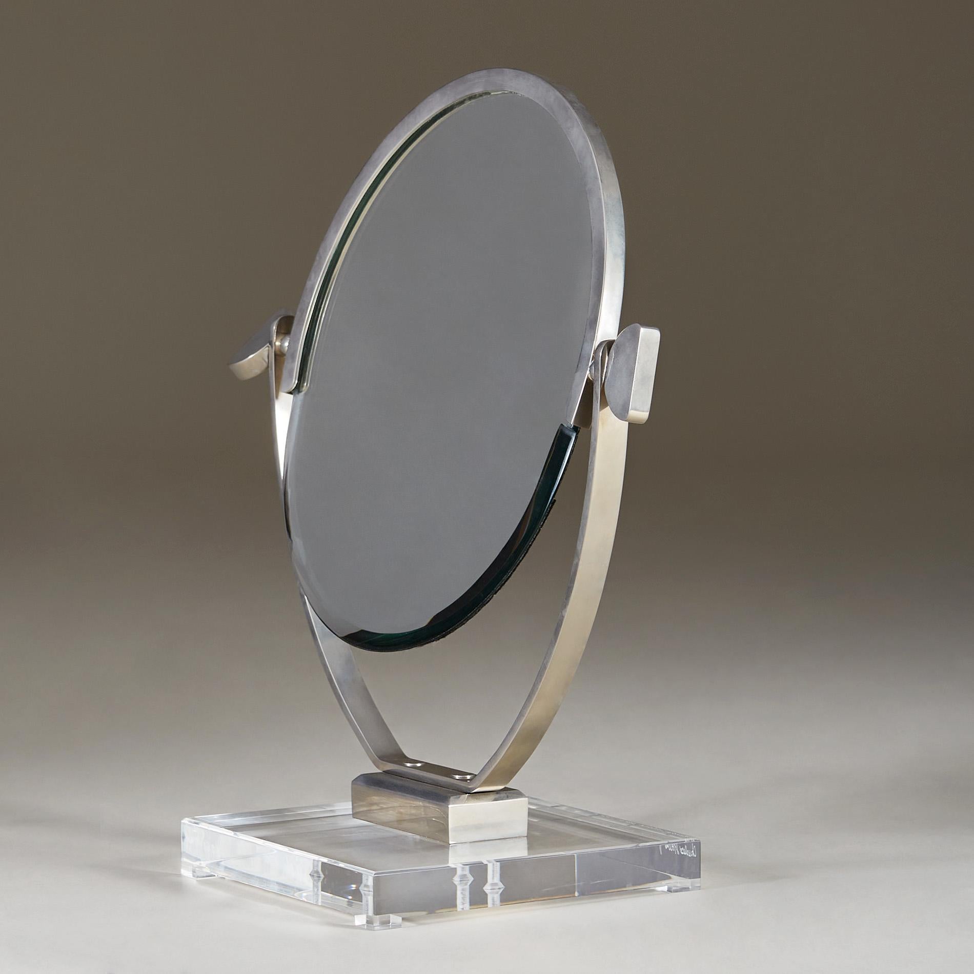 Rare mid-century modern double-sided bevelled mirror perfectly balanced on a heavy square lucite base. Decorative pebble shaped chrome screw handle on each side allows you to adjust the position of the mirror.

Signed and dated Charles Hollis Jones