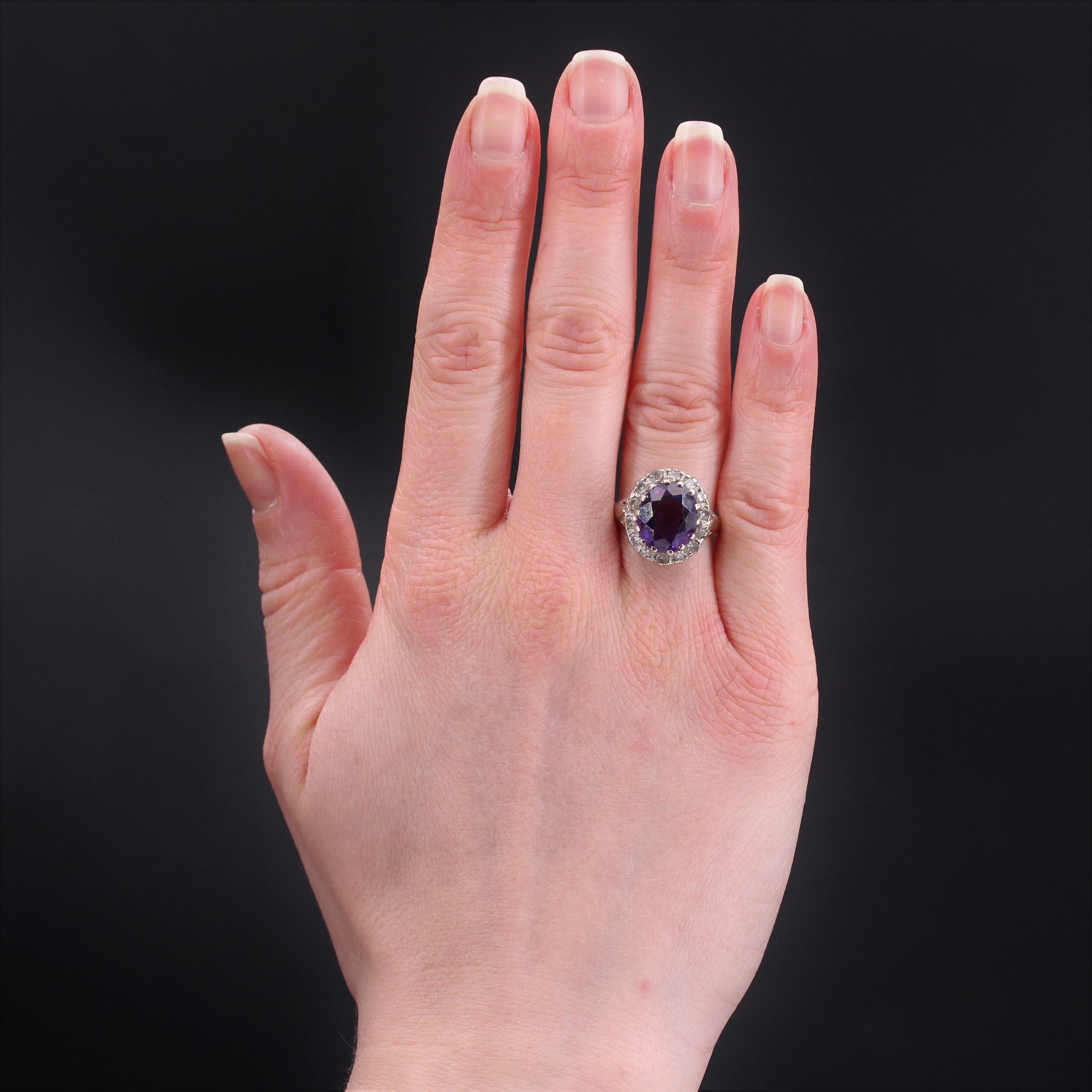 Ring in 18 karat white gold, owl hallmark.
Elegant retro ring, it is set with claws in the center of a faceted amethyst in a surround of 8/8 cut diamonds.
Total weight of the amethyst : 4 carats approximately.
Total weight of the diamonds : 0.42