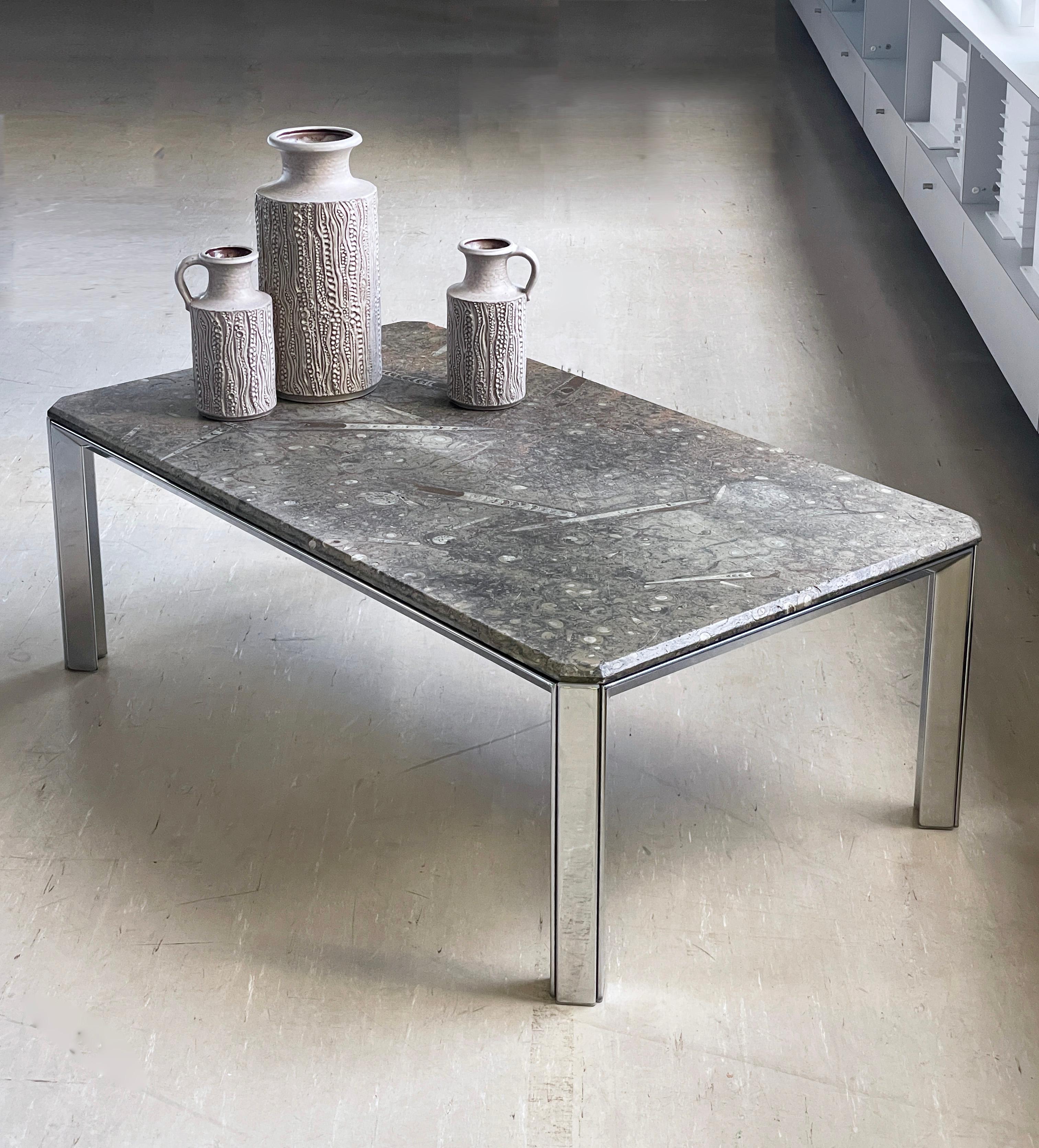 Incredible 1970’s Fossil Lounge Table. Solid natural stone tabletop, sat on a polished aluminium base. The heavy natural stone tabletop is absolutely unique, with a cross-section of ammonite and orthoceras fossils. Truly jurassic! Would sit well in