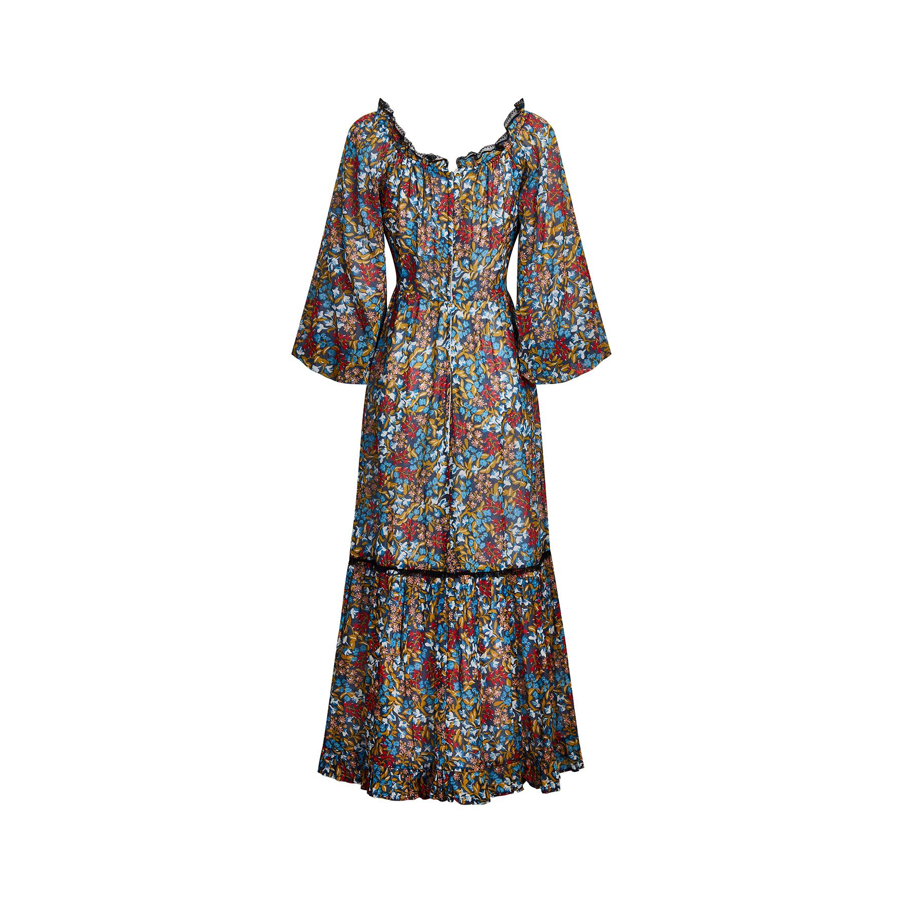 This original 1970s boho maxi dress is by upmarket British boutique label Angela Gore has a really fantastic mixed floral print; we can identify fuchsias and snowbells amongst others. It has an empire waistband and a floor length A-line skirt with a