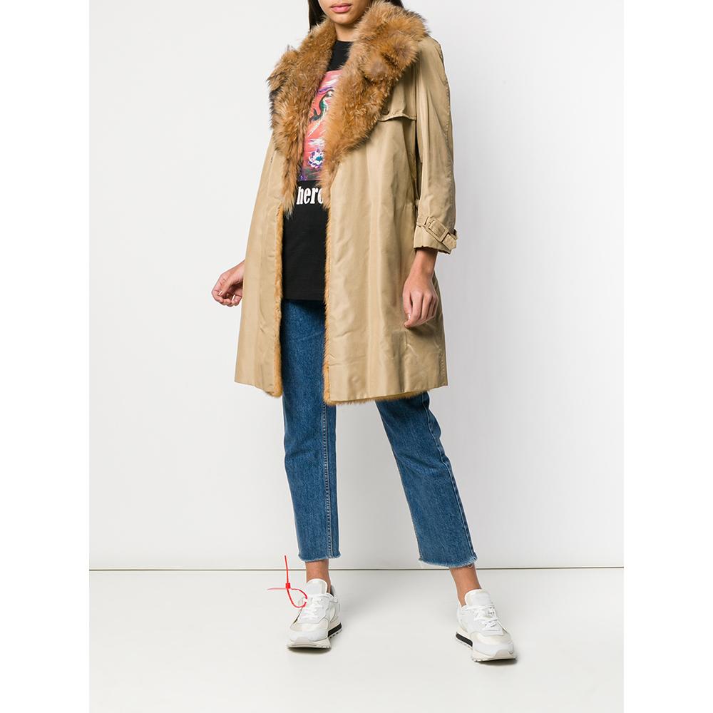 A.N.G.E.L.O. Vintage Cult beige fabric trench. Classic lapel collar covered in fox fur, front closure with hook and belt at the waist. Windbreak flap, rain flap on the back. Long sleeves and cuffs with strap. Interior lined in mink fur.

Flat