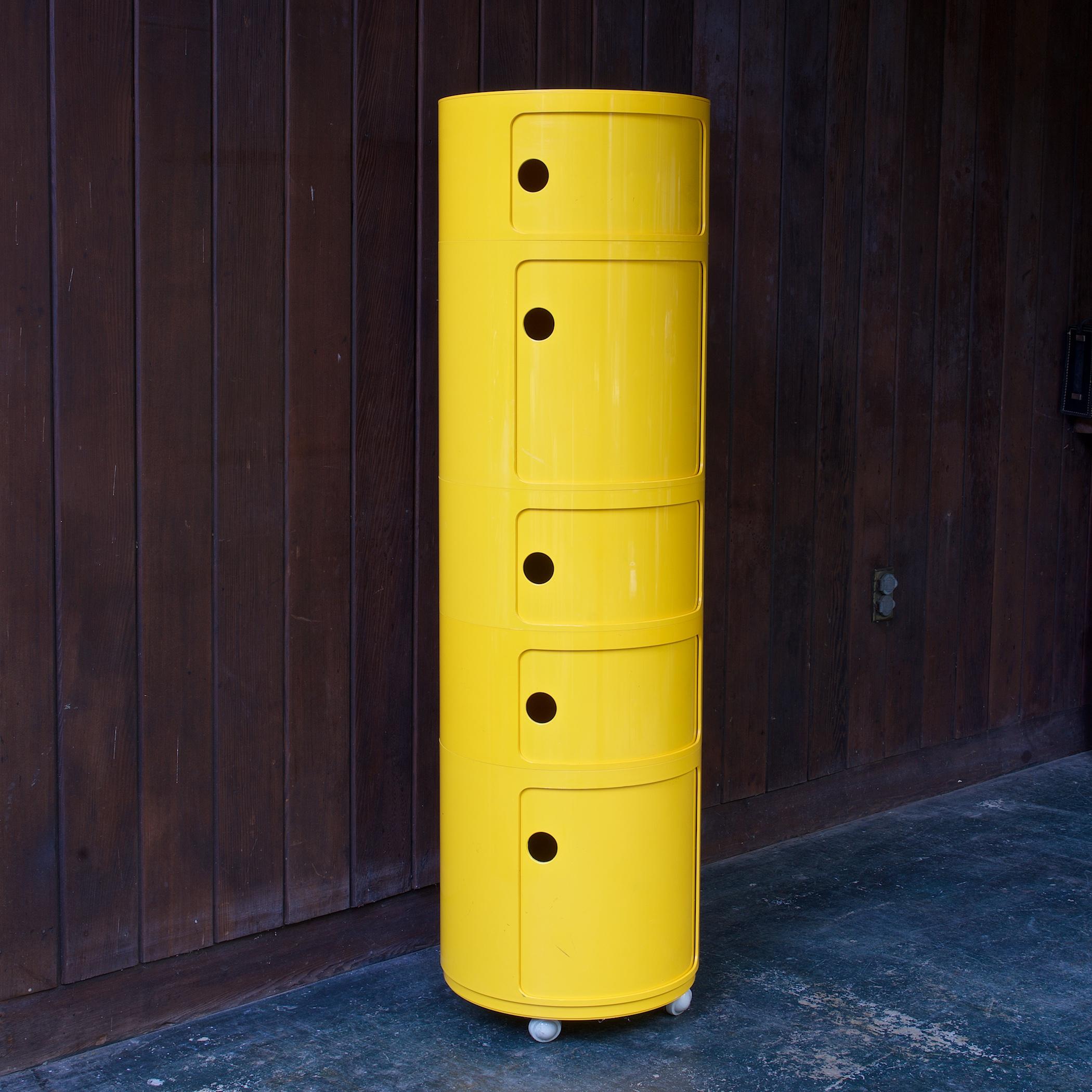 1970s original production Componibili storage units in bright primary yellow by Anna Castelli for Kartell, Beylerian, ltd.  5-tier stack with sliding doors on casters.

Includes:
(2) Tall Units Each with Dia 16.5 x H 15 1/8 in.
(3) Short Unit Dia