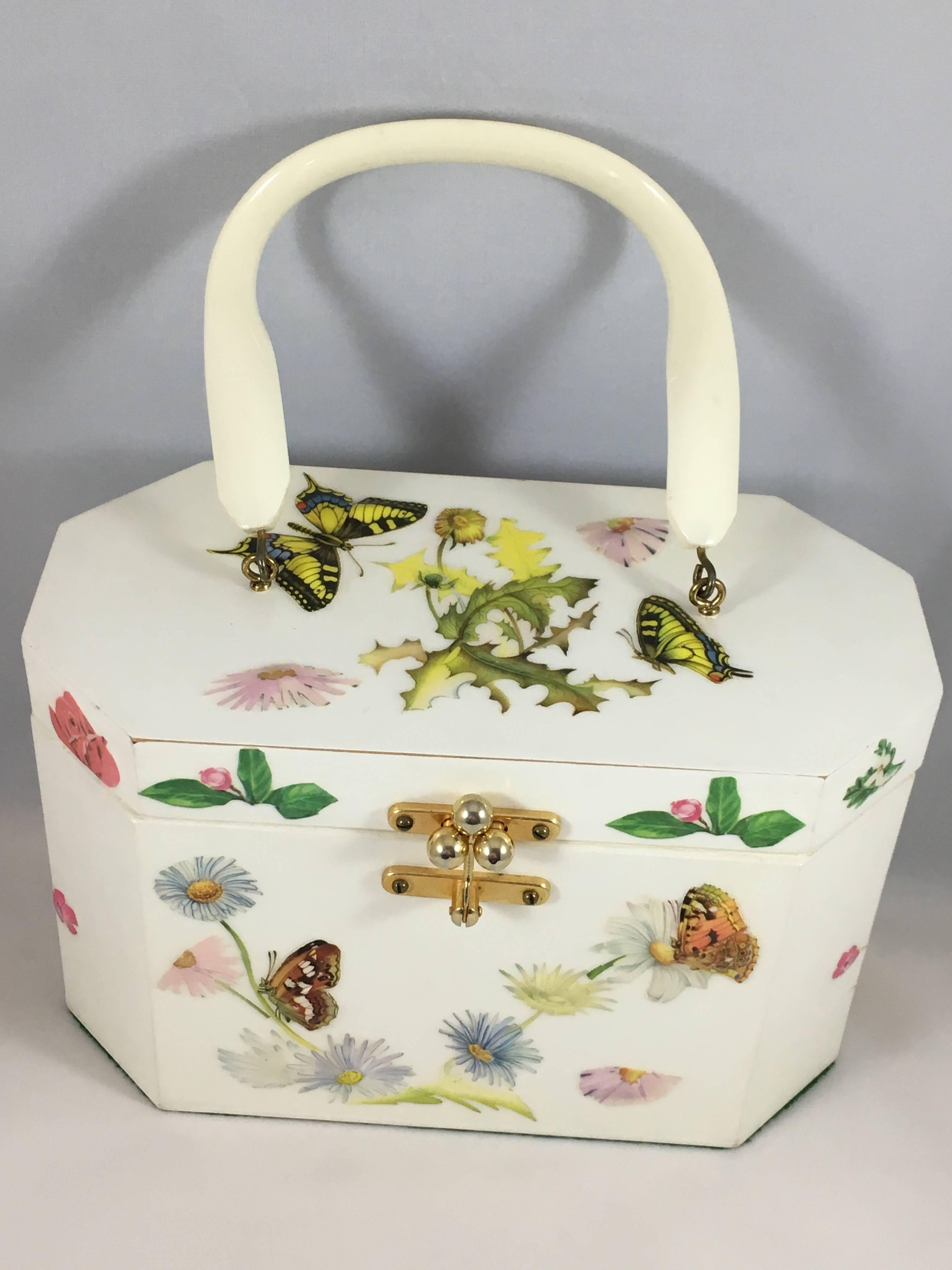 This is a fabulous 1970s Annie Laurie Originals of Palm Beach butterfly decoupaged purse. It is a wooden box handbag with an off white background decorated with puffy decoupaged butterflies and flowers. It fastens at the front with Annie Laurie's