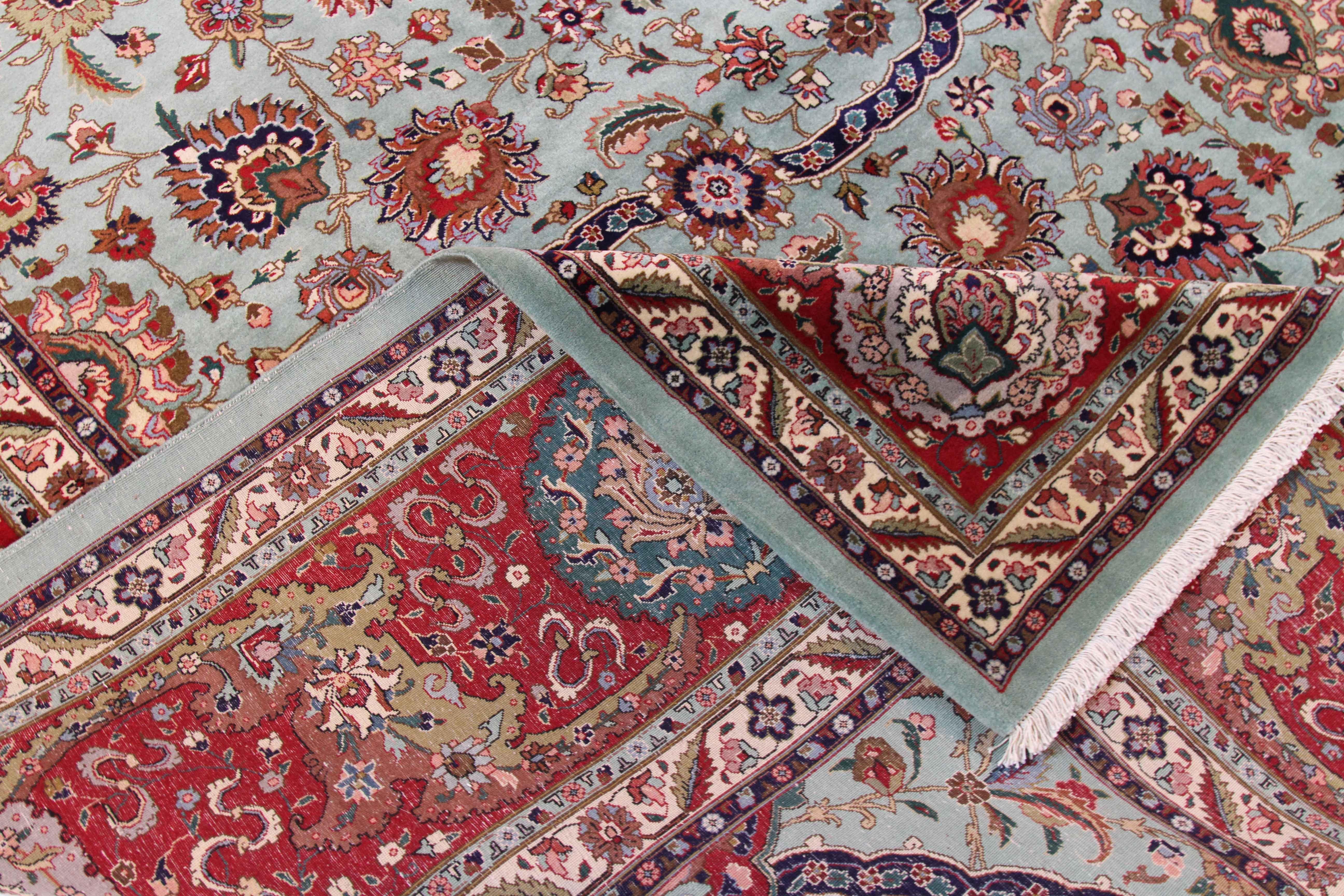 1970s antique Persian rug hand knotted from the finest wool and all-natural plant-based dyes. It features a majestic floral field design in blue and red with hints of navy and green. It’s border has beautiful alternating ‘Boteh’ figures that further