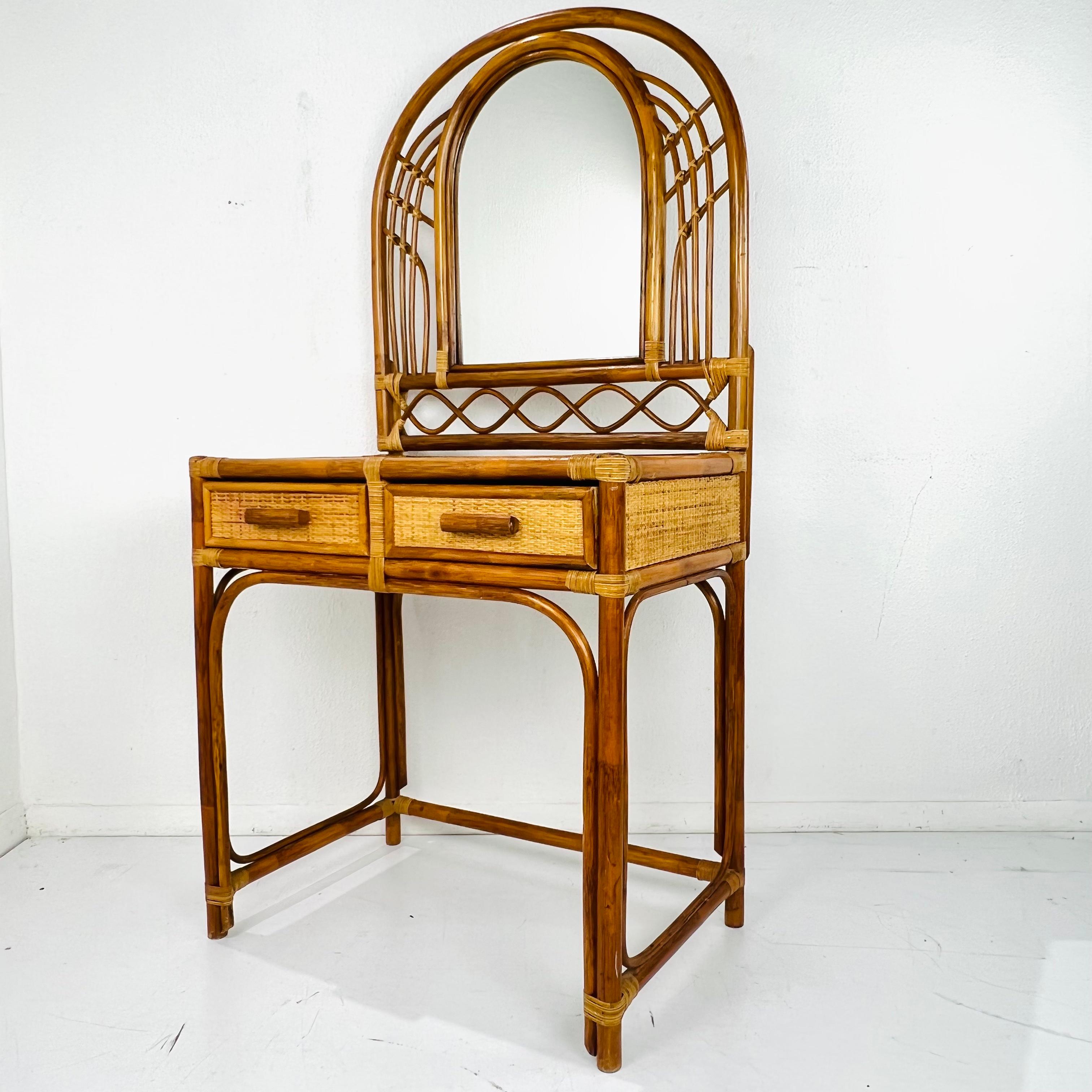 Super cute 1970s rattan vanity, consisting of a table with two drawer and arched mirror. Fits perfectly in a midcentury or Bohemian style home. Very good vintage condition with some minor signs of age and use. 