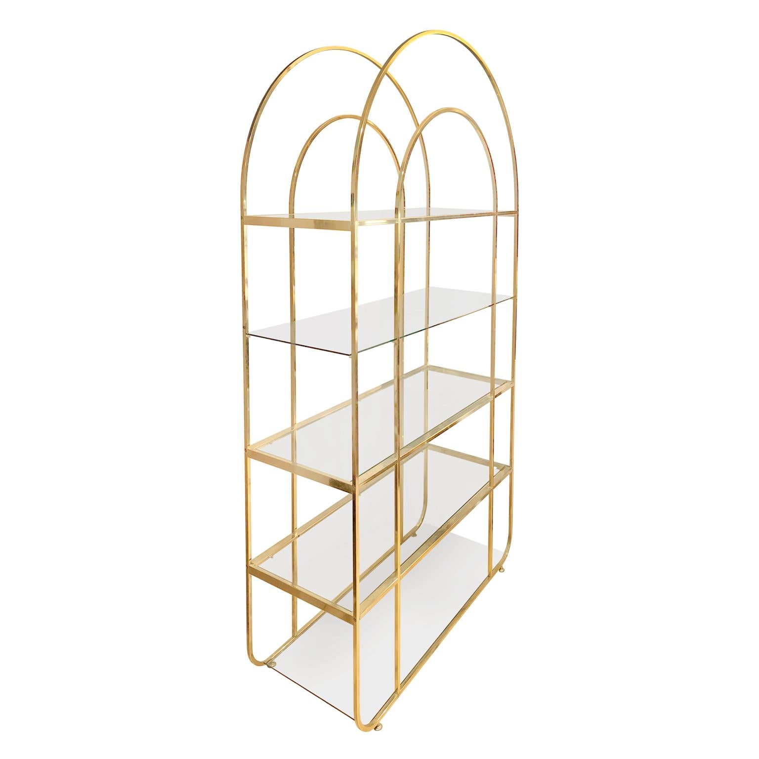 Arched top brass étagère with five glass shelves, USA, 1970s.